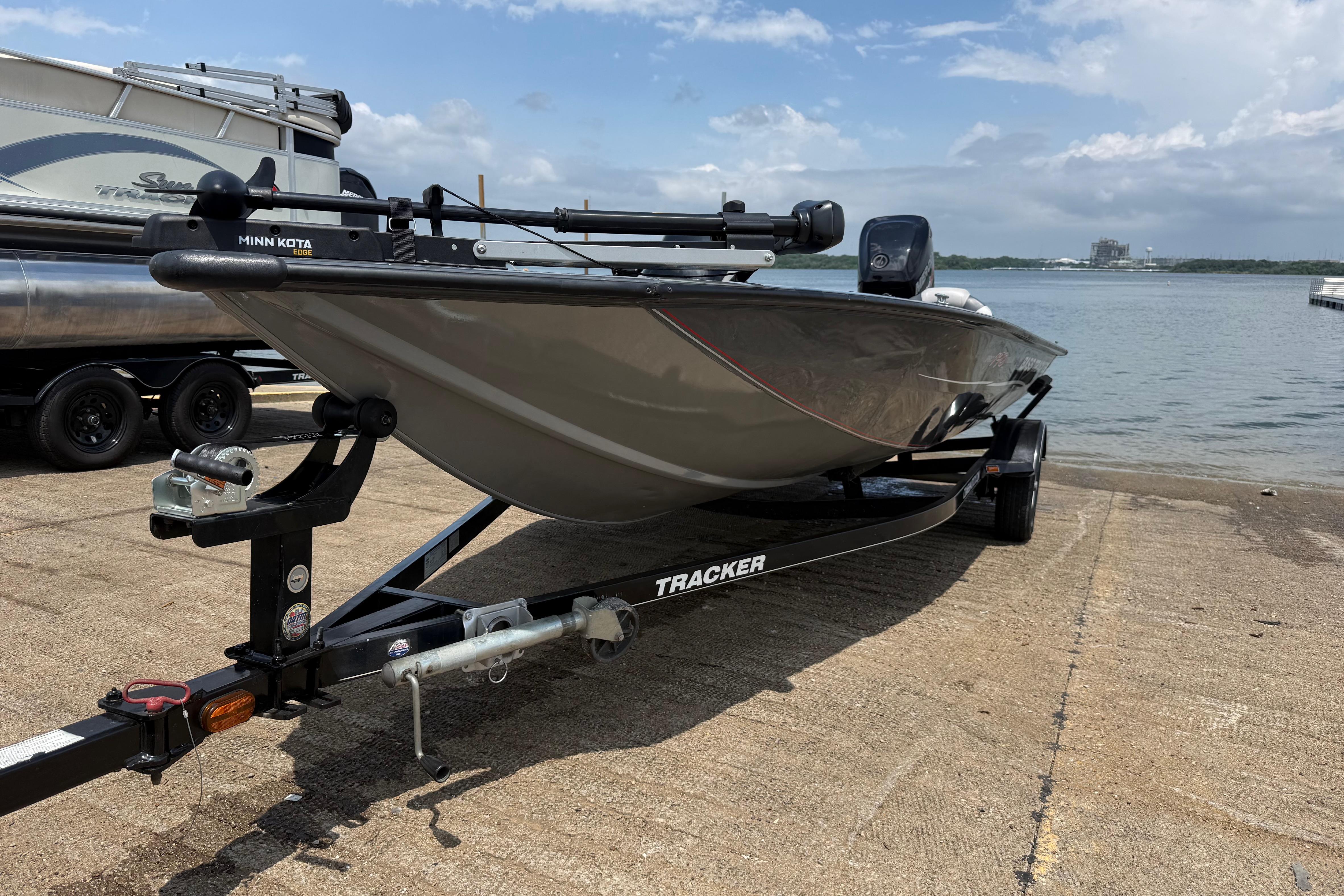 2015 Tracker Pro Team 190 TX boat on trailer by the water.