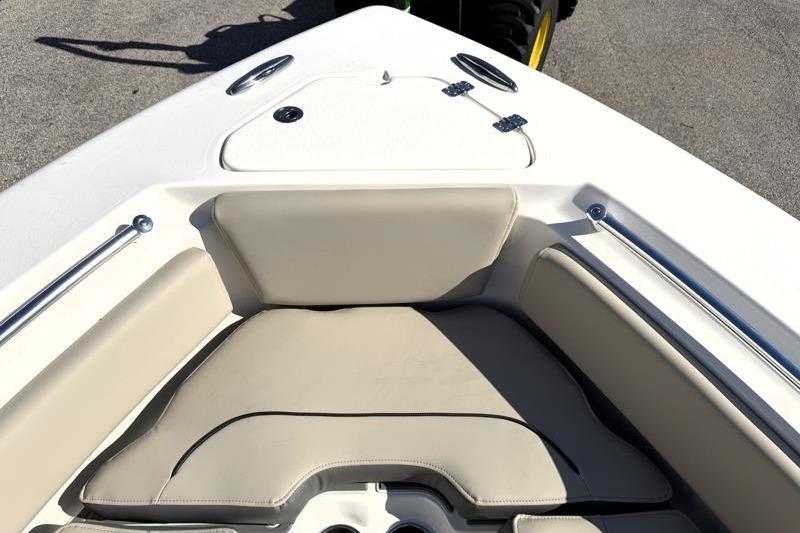 2025 Key West 239 FS boat interior with beige seating and stainless steel rails.