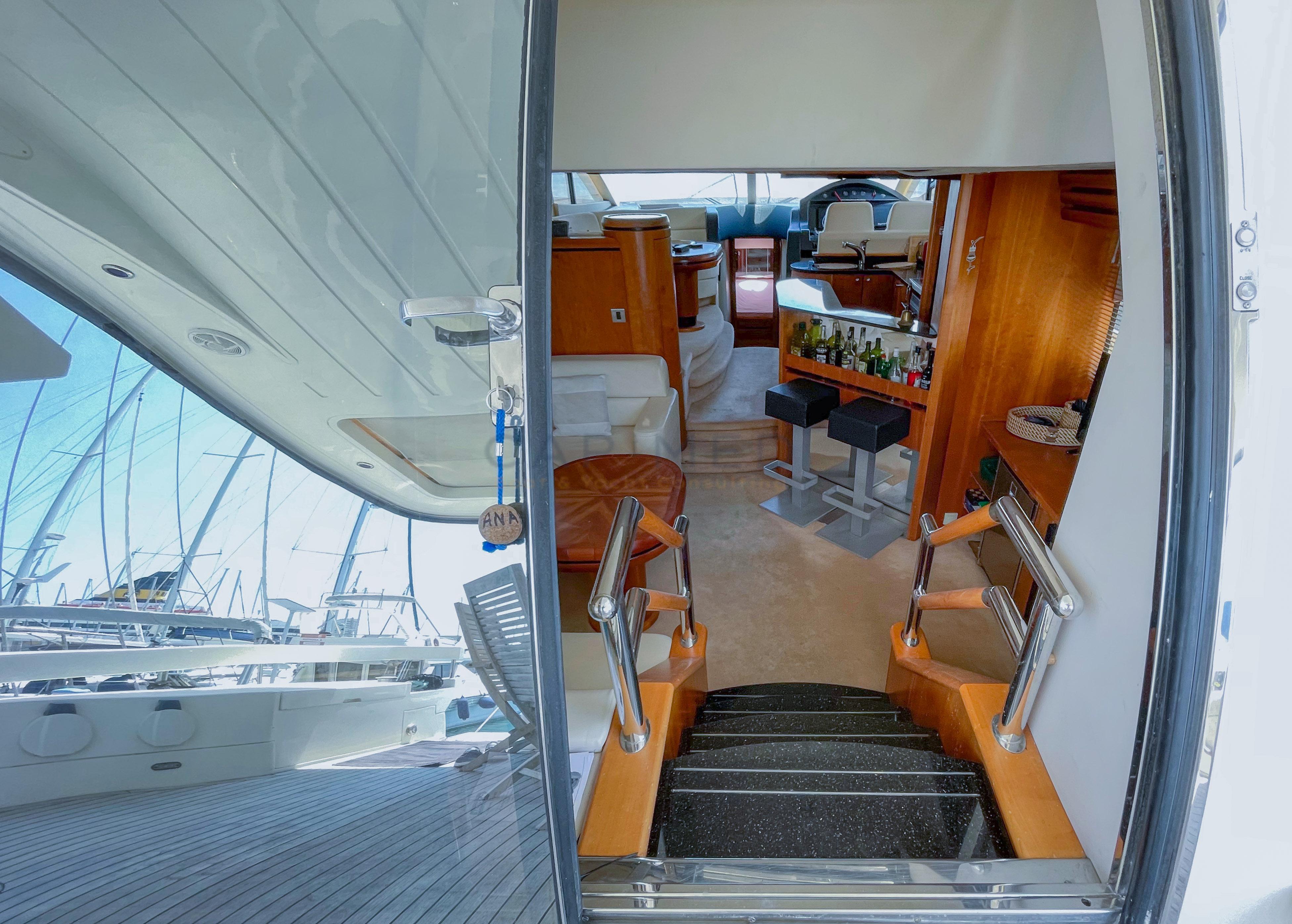 Interior view of a 2006 Pearl 60 yacht, showcasing luxurious seating and bar area.