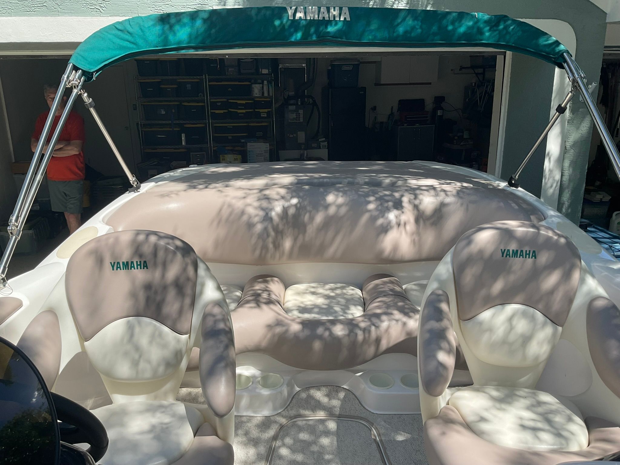 2000 Yamaha LS2000 boat with green canopy and beige seats.