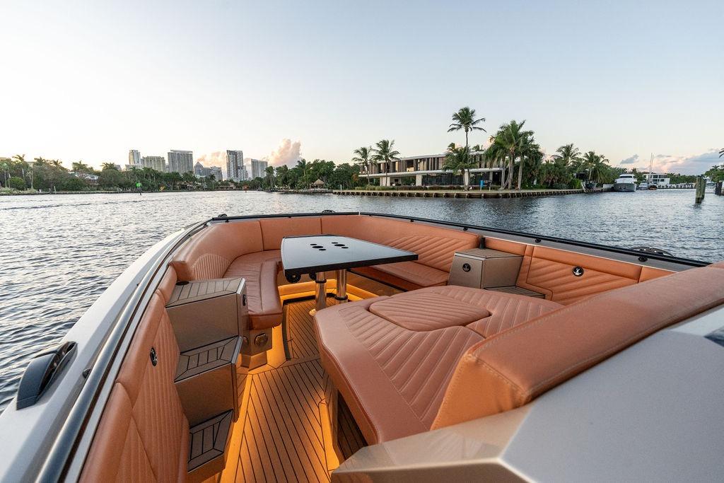 Luxurious 2023 DeKoning 43 boat interior with elegant seating and waterfront view.