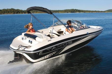 2012 Tahoe Q4 SS boat cruising on a lake with two passengers.