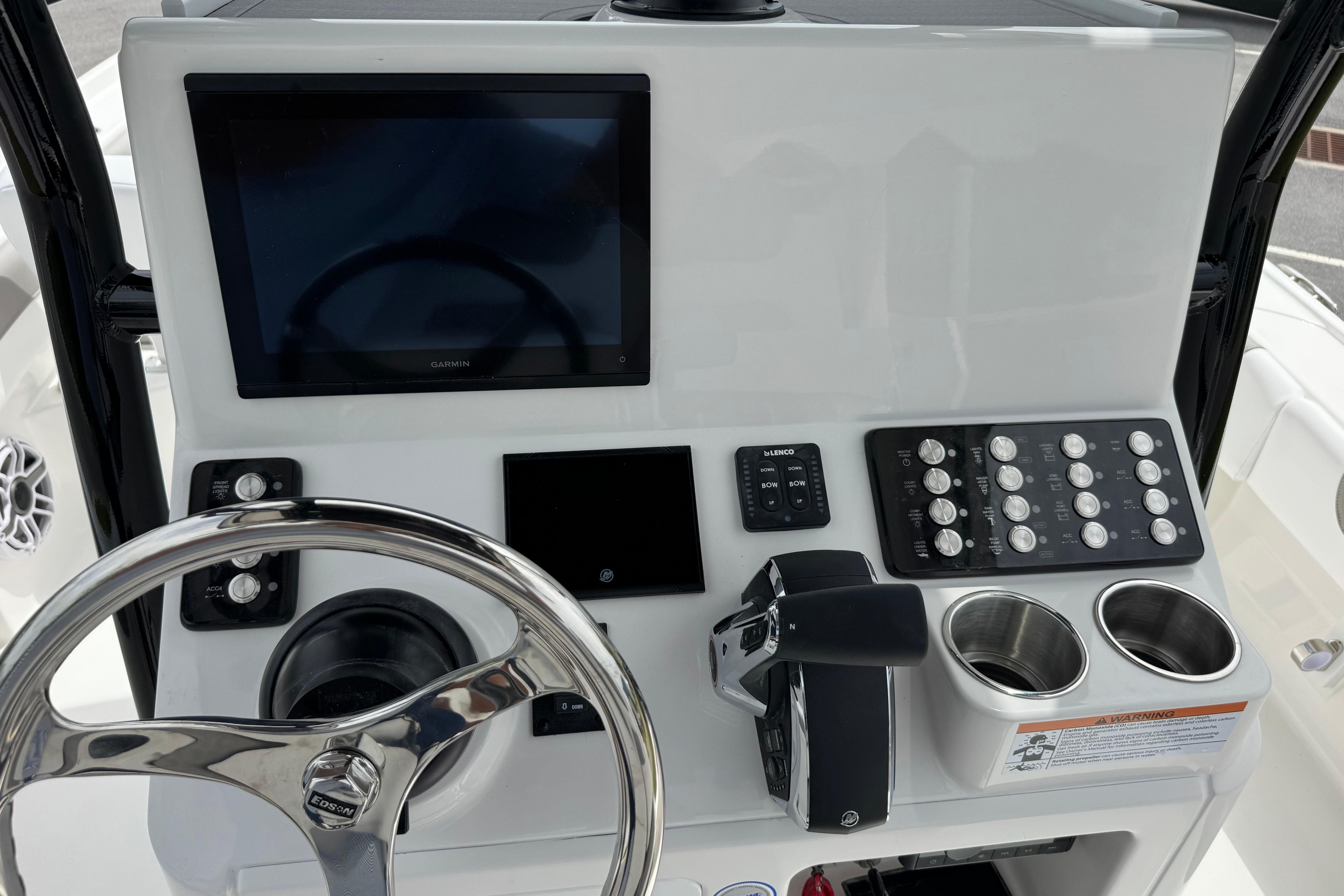 Control panel of 2027 Caymas 26 HB boat with steering wheel and electronic displays.
