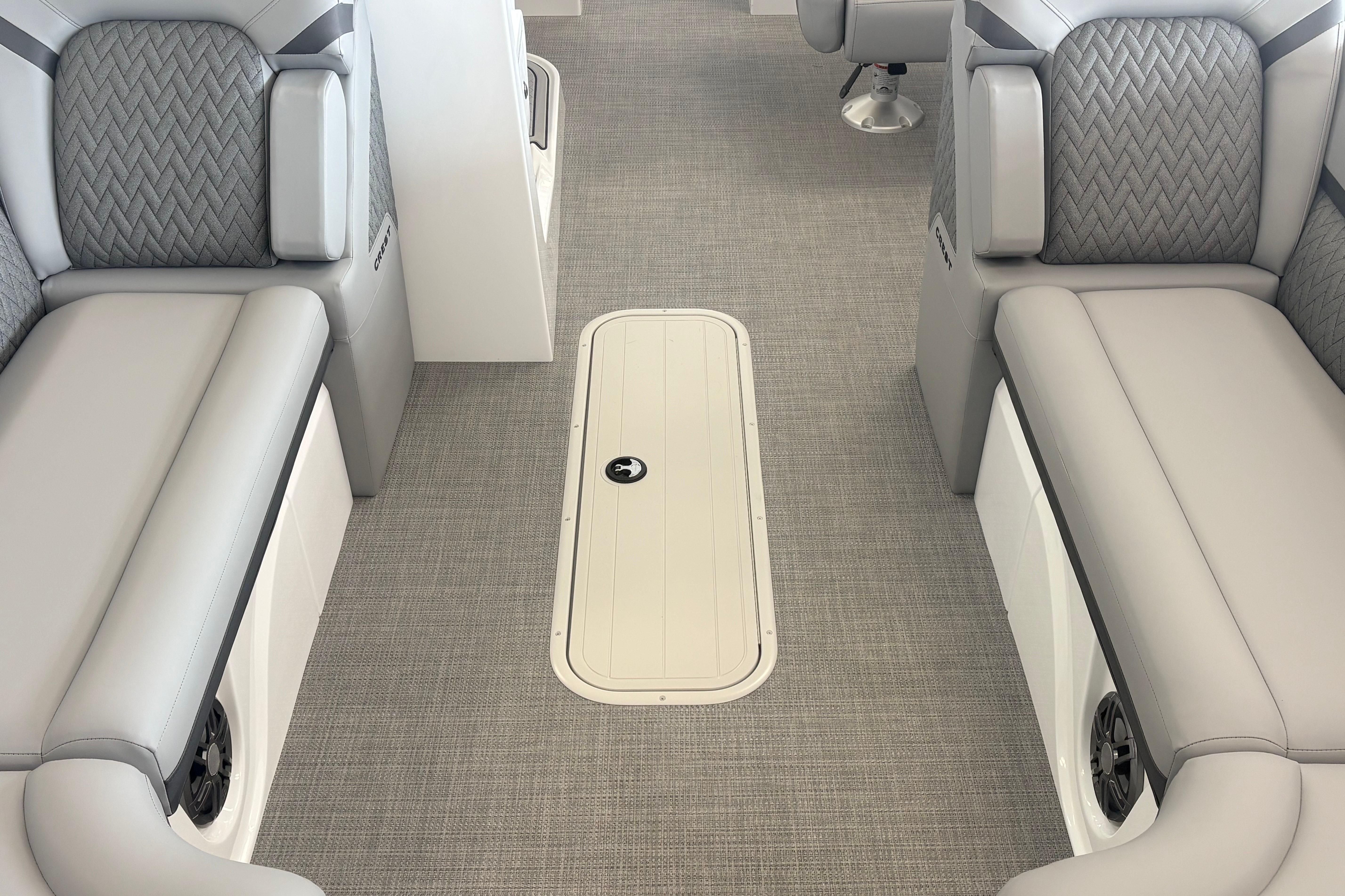 Interior of 2026 Crest 230 SLRC Caribbean boat with gray seating and carpeted floor.