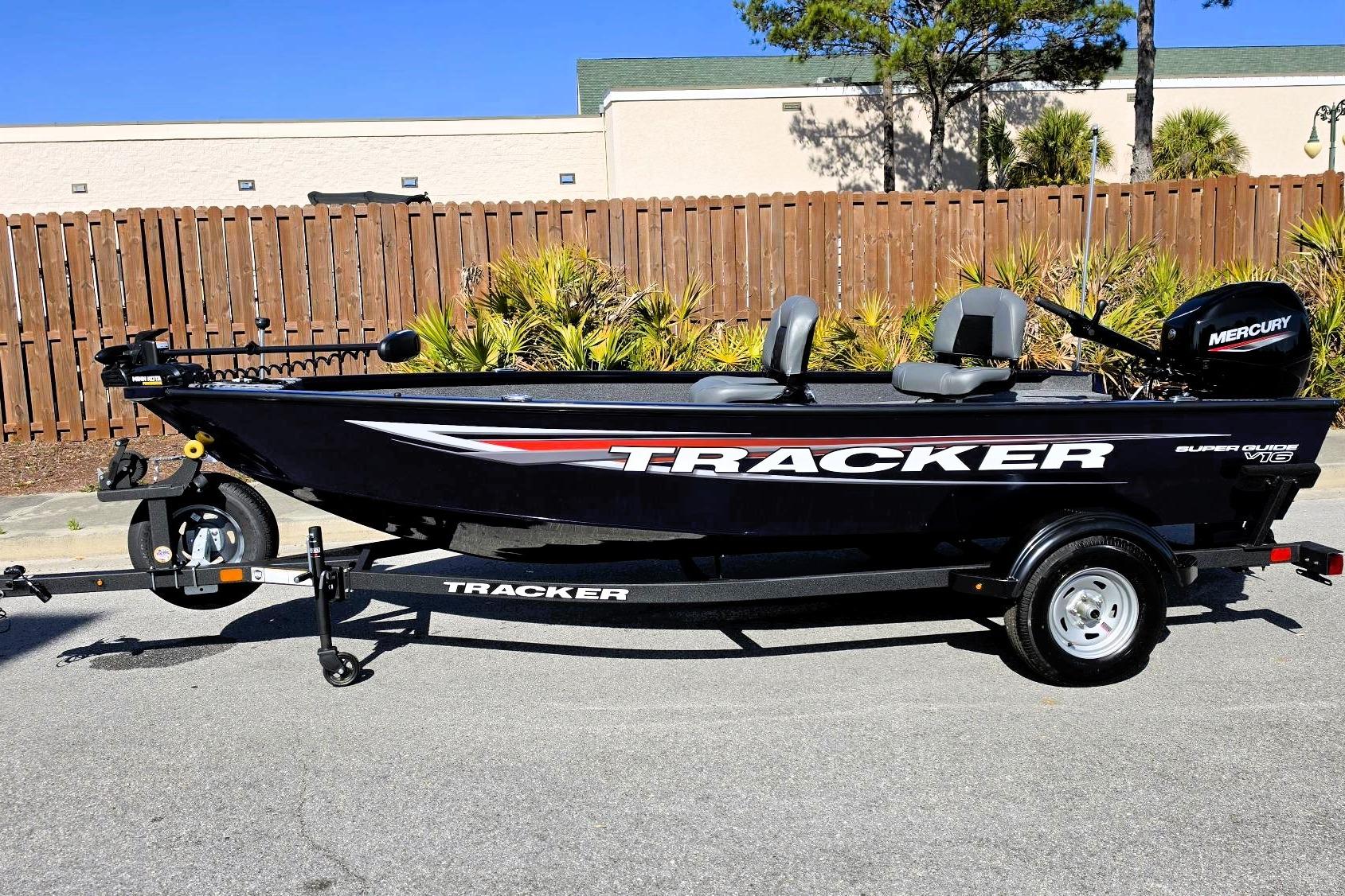 2026 Tracker Super Guide V-16 T boat on trailer, parked outdoors.