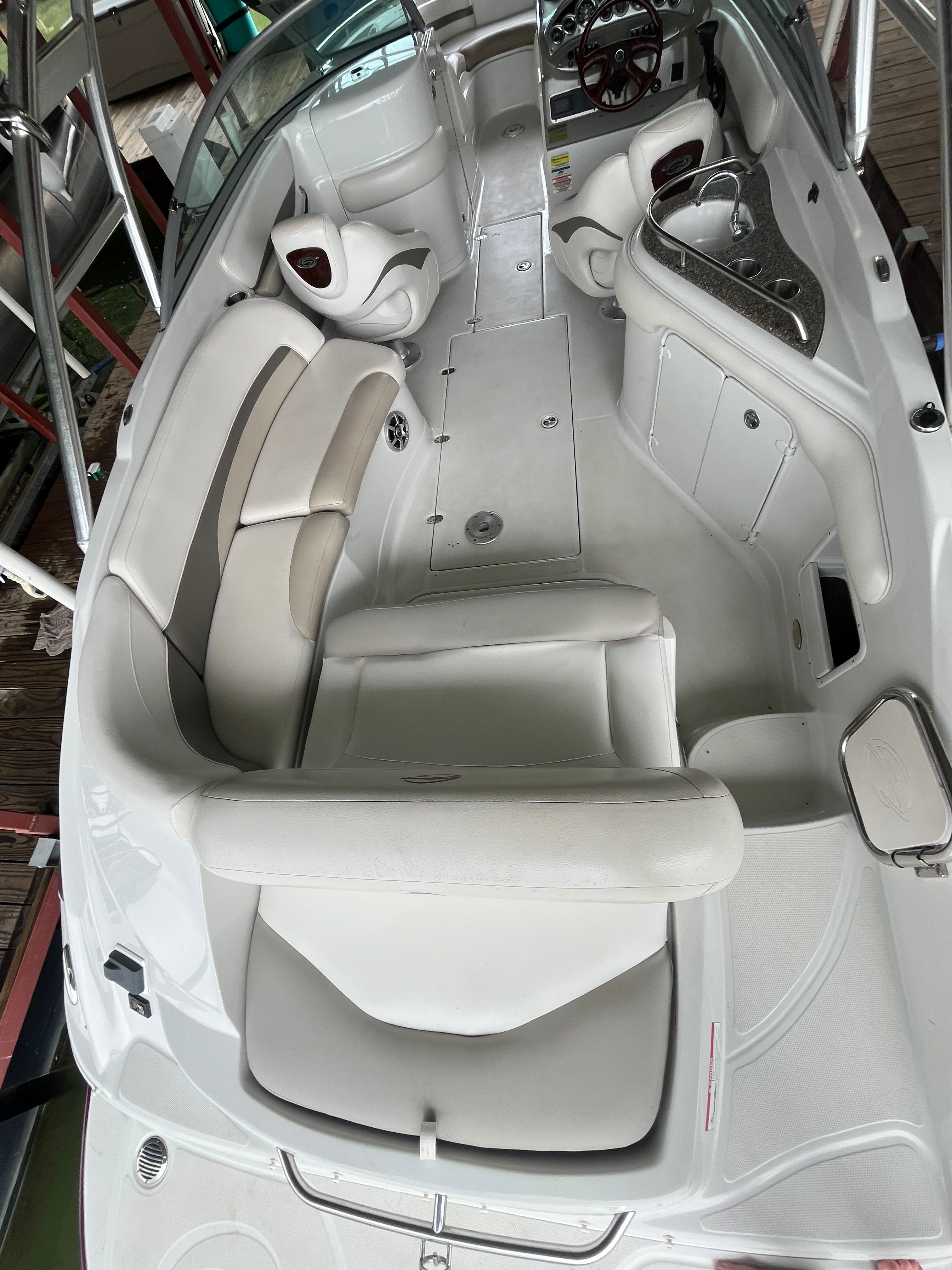Interior view of a 2008 Crownline 252EX boat with white seating and helm console.