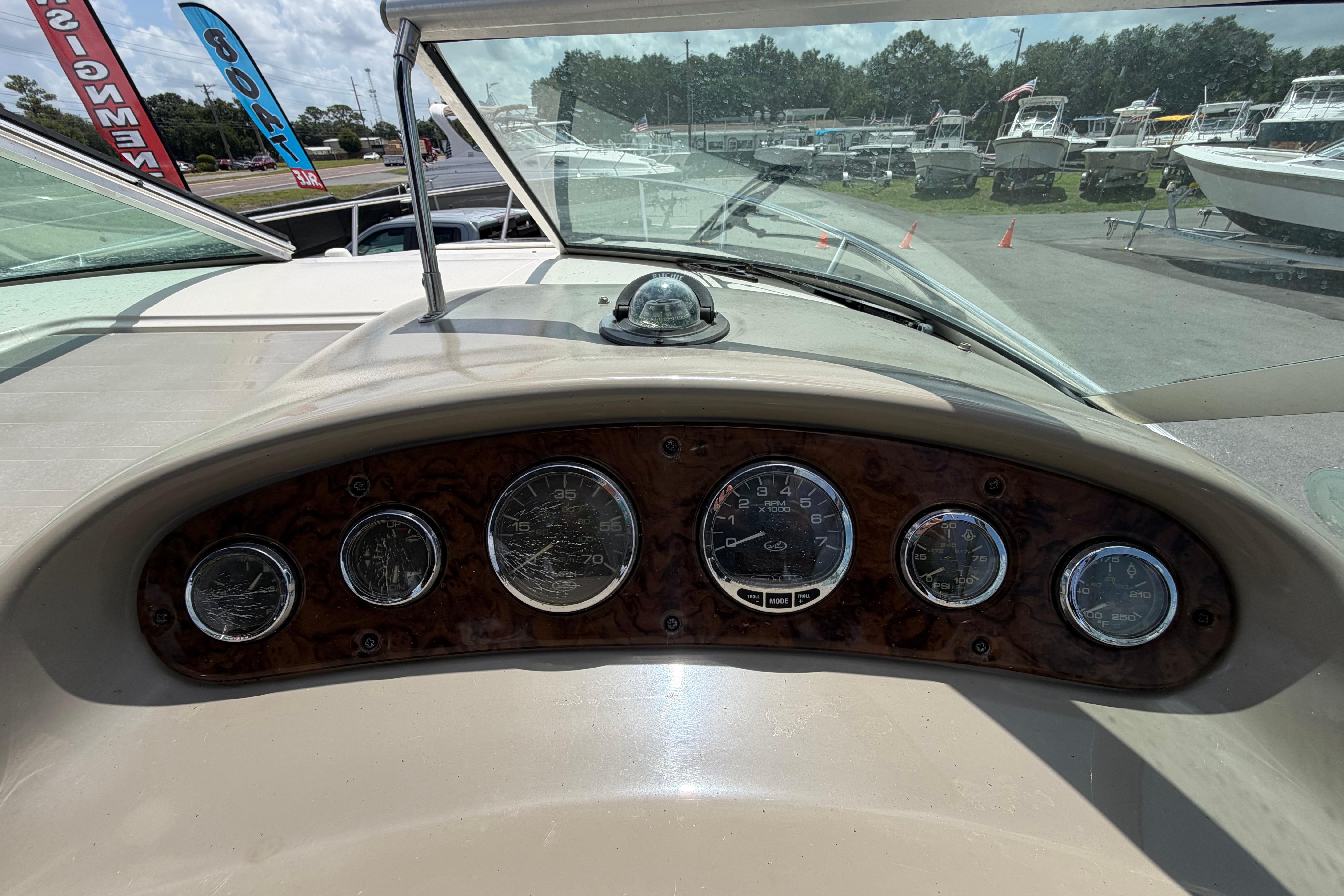 Dashboard of a 2006 Sea Ray 250 Amberjack boat with gauges and compass.