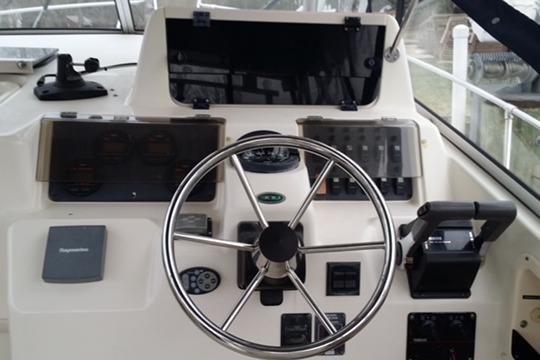 Steering console of a 2002 Grady-White Marlin 300 boat with navigation equipment.