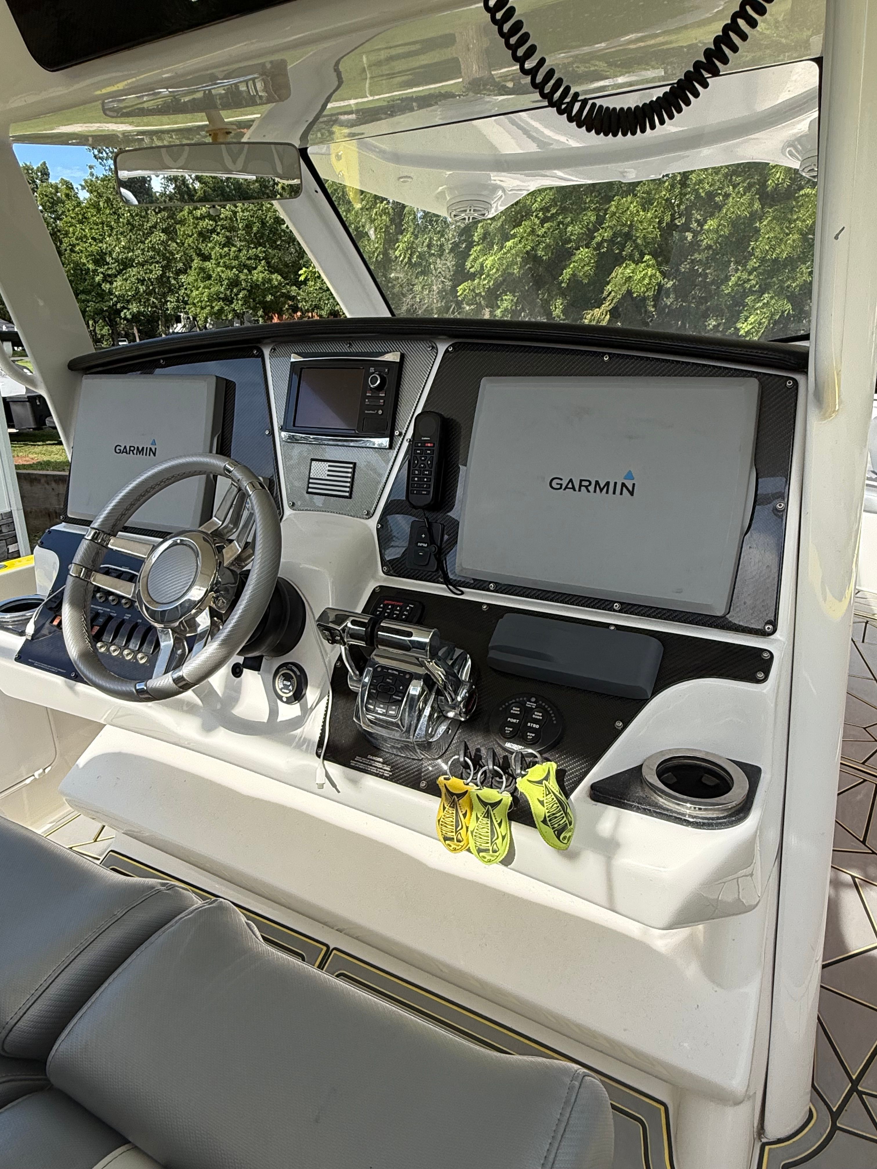 The image shows the cockpit of a 2014 Sunsation 34 CCX with Garmin screens and controls.
