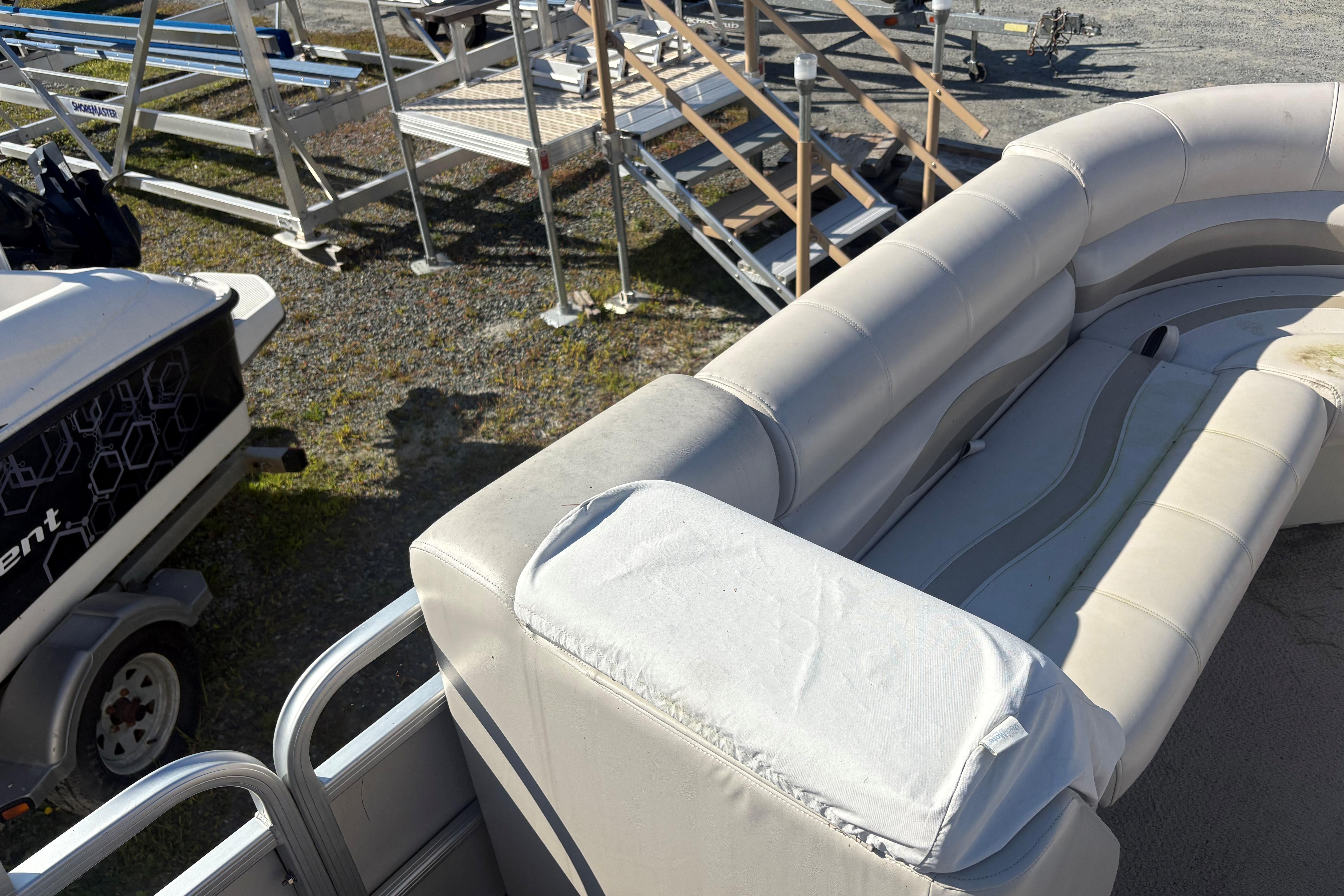 2003 Aqua Patio 200RE pontoon boat with white seating and metal railings.