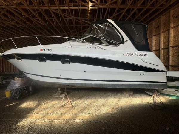 2005 Four Winns 298 Vista boat in storage, side view.