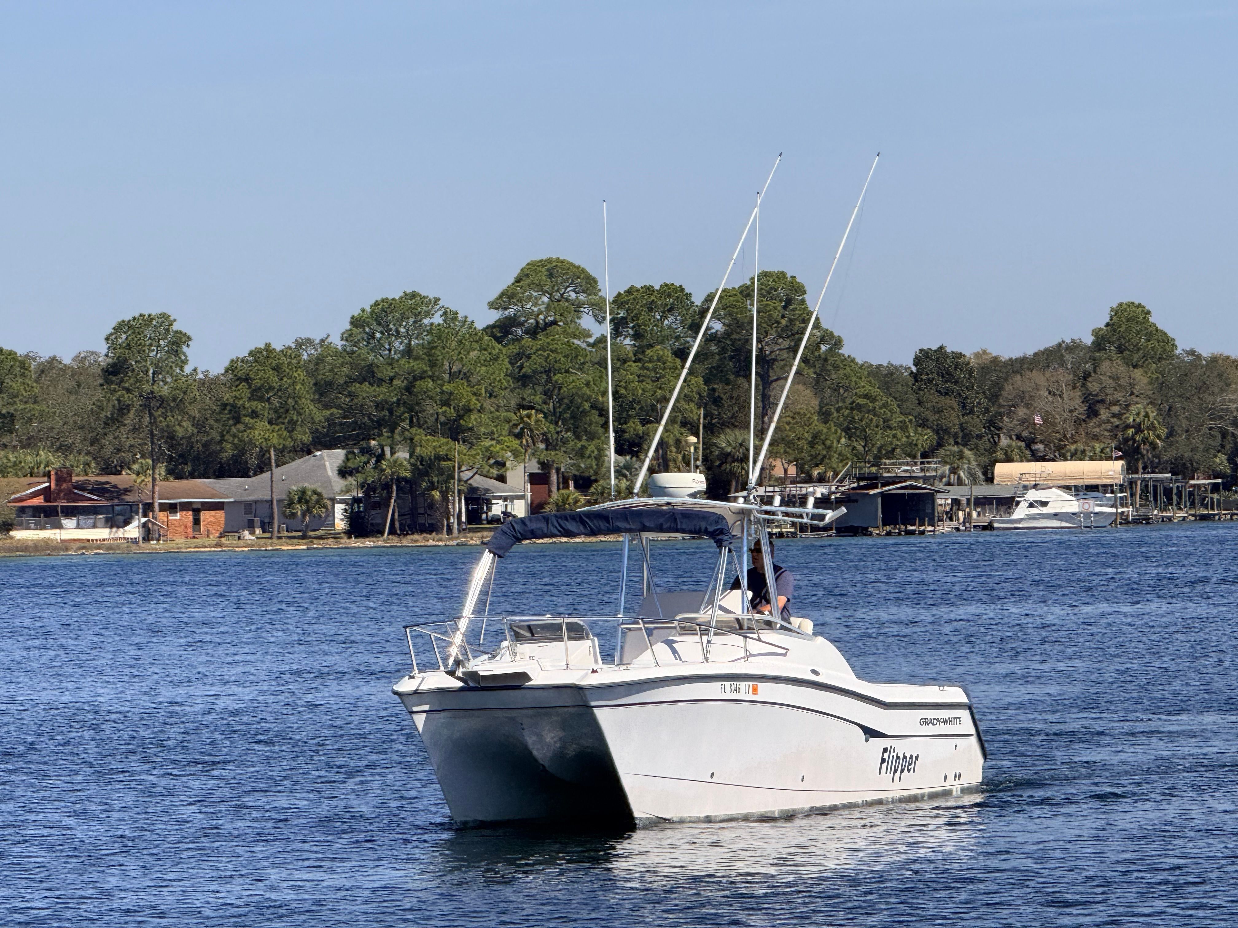 Grady-White X26 Tigercat 2000 on calm water near coastal homes.