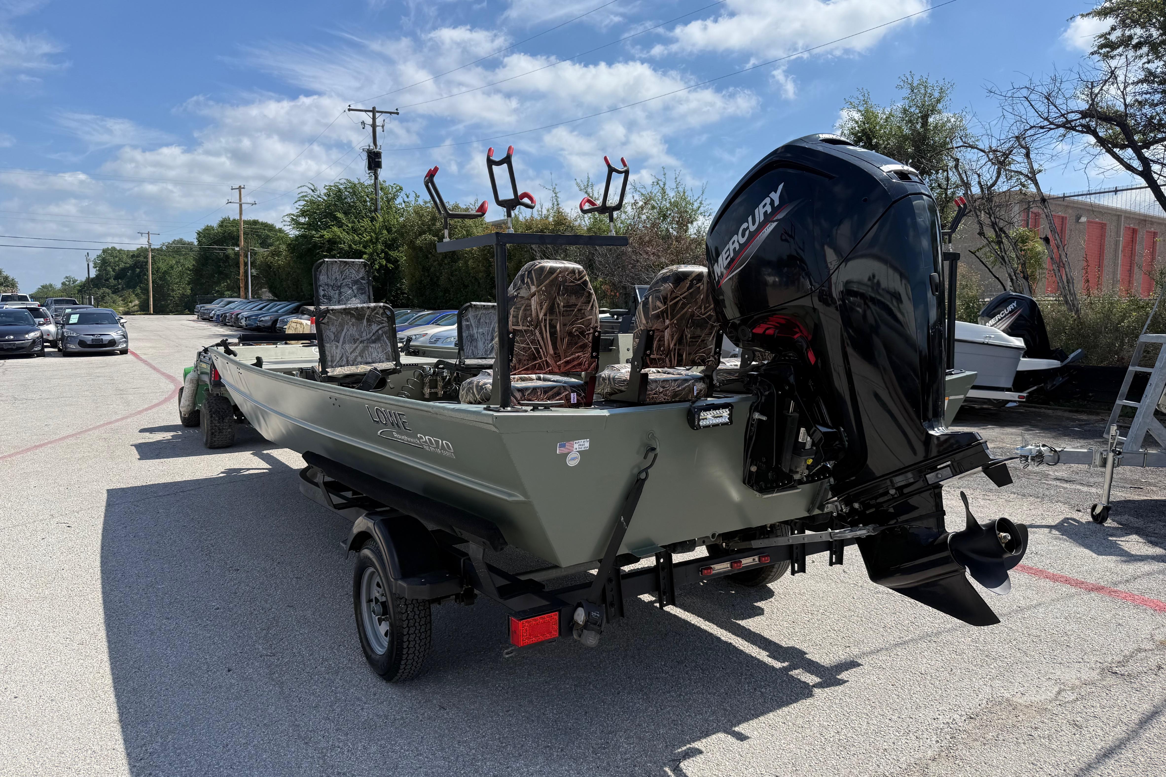 A 2020 Lowe Roughneck 2070 Big River boat on a trailer, featuring a Mercury outboard motor.