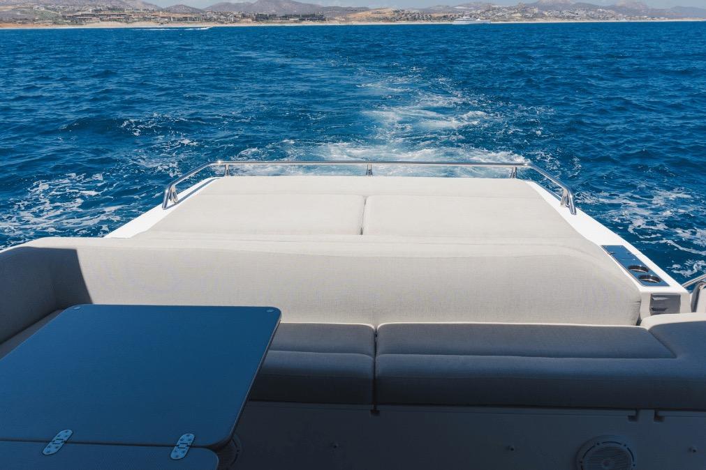 Luxury Azimut 60 yacht cruising on open sea, 2020 model, with spacious deck seating.