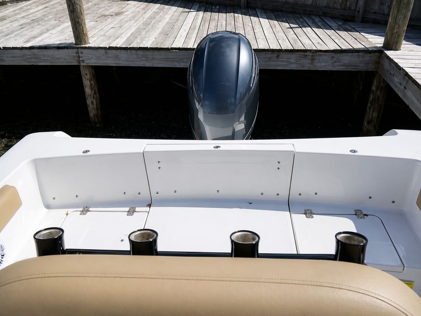 Rear view of a 2018 Sportsman Heritage 231 Center Console boat at dock.