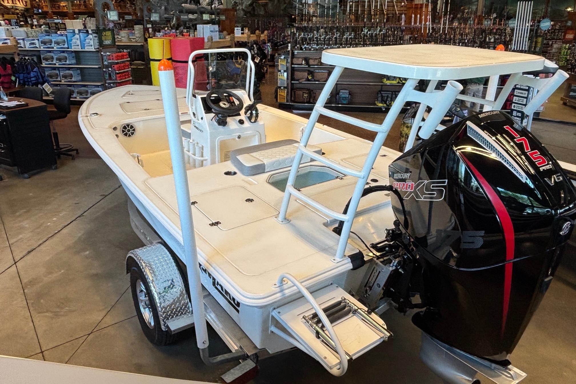 2026 Mako 18 Pro Skiff boat with Mercury Pro XS engine in showroom.