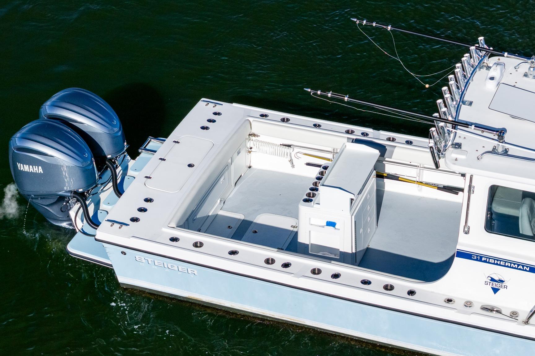 2024 Steiger Craft 31 Fisherman boat with dual Yamaha engines on water.