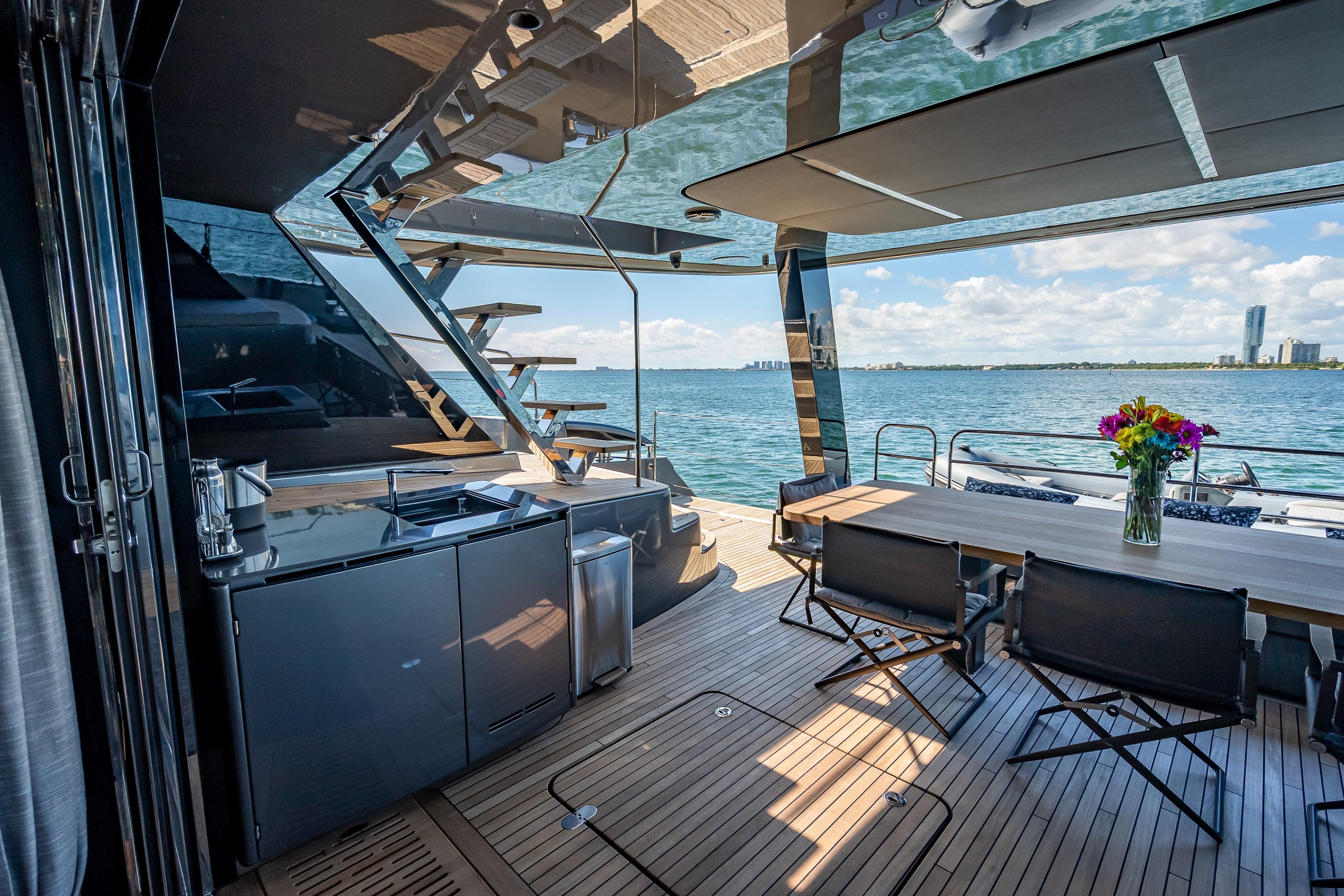Luxurious Sunreef 60 Power yacht deck with modern kitchen and dining area, overlooking the ocean.