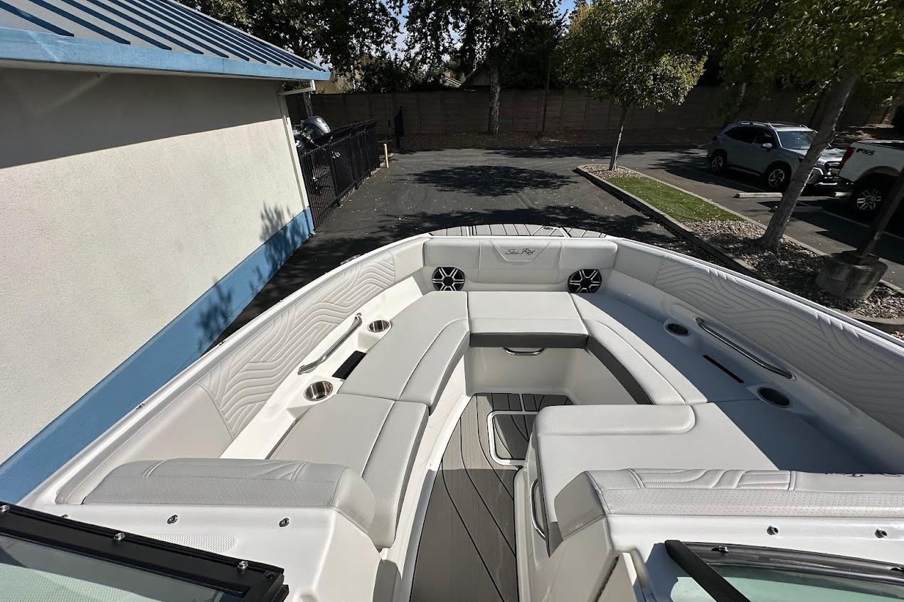 2026 Sea Ray SDX 230 Surf boat interior with white seating and cup holders.