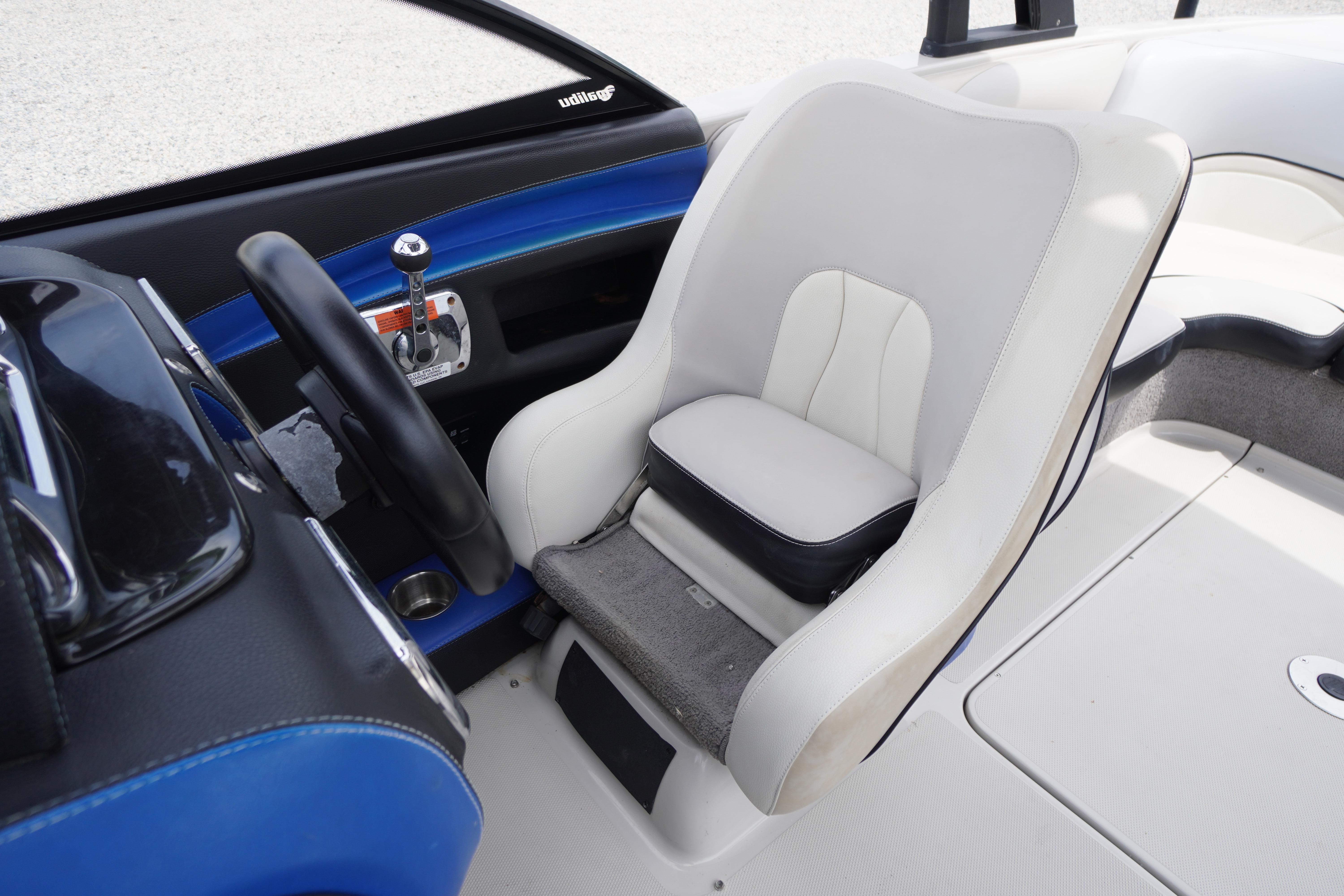 2011 Malibu Wakesetter 21 VLX boat interior with steering wheel and captain's seat.