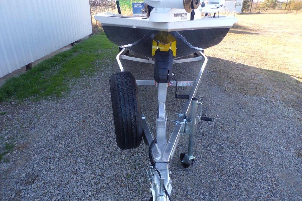 2026 Xpress H20B Bay boat on trailer, parked on gravel.