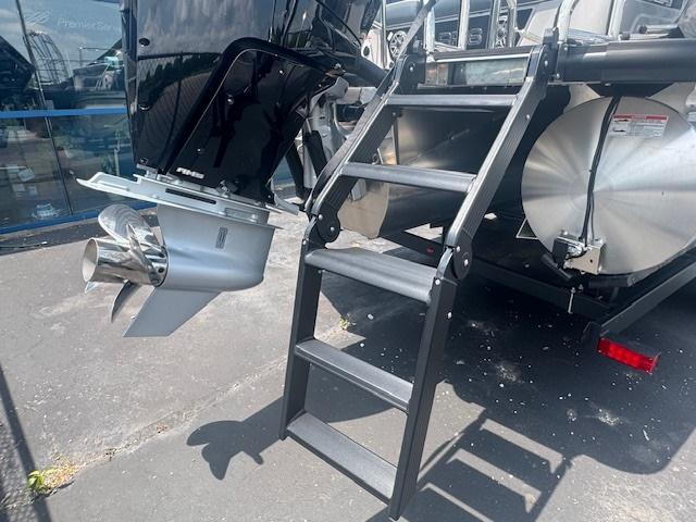 2025 Harris Grand Mariner 250 boat with ladder and outboard motor.