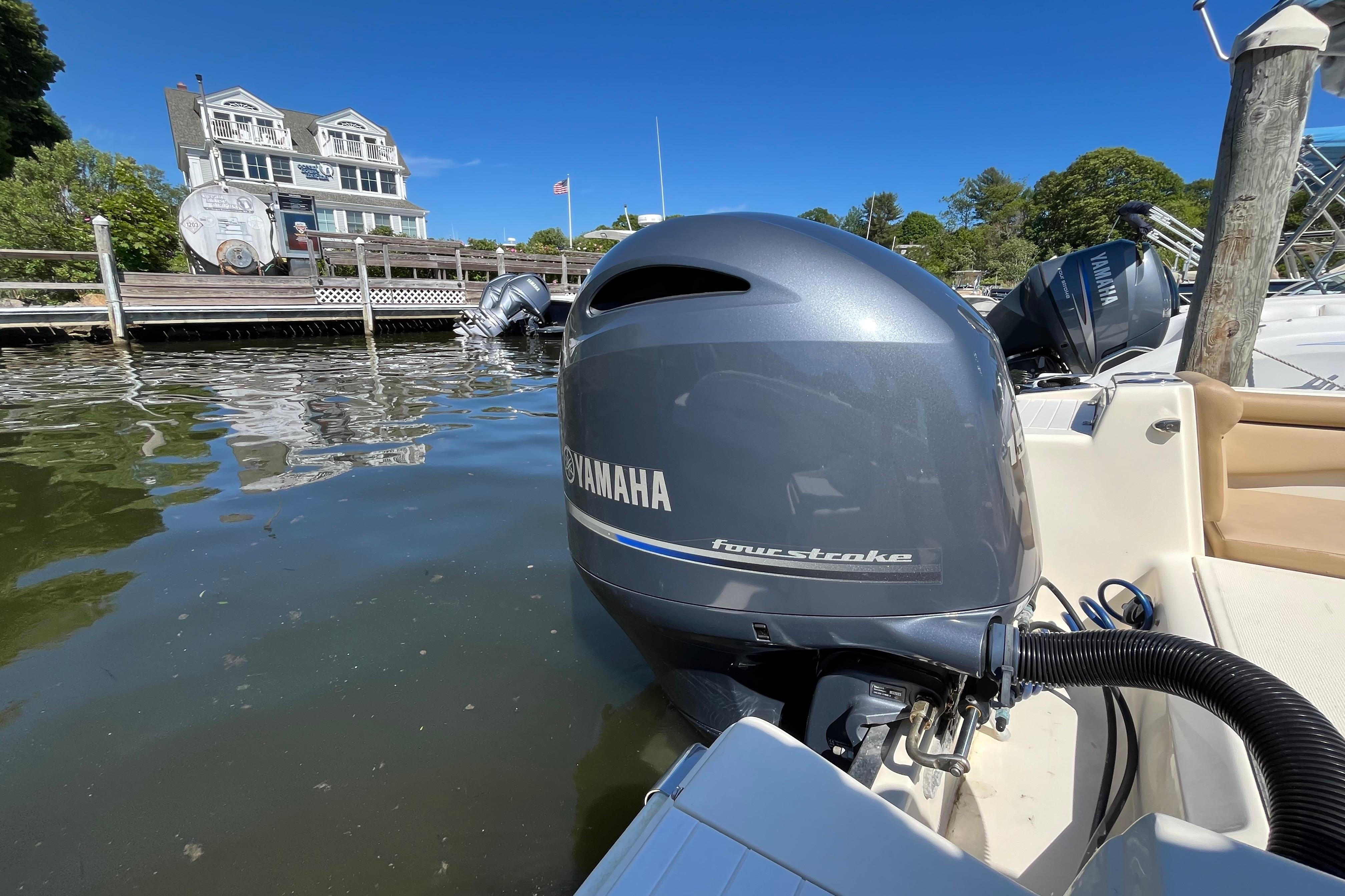 2017 Scout 210 Dorado with Yamaha four-stroke engine docked by waterfront home.