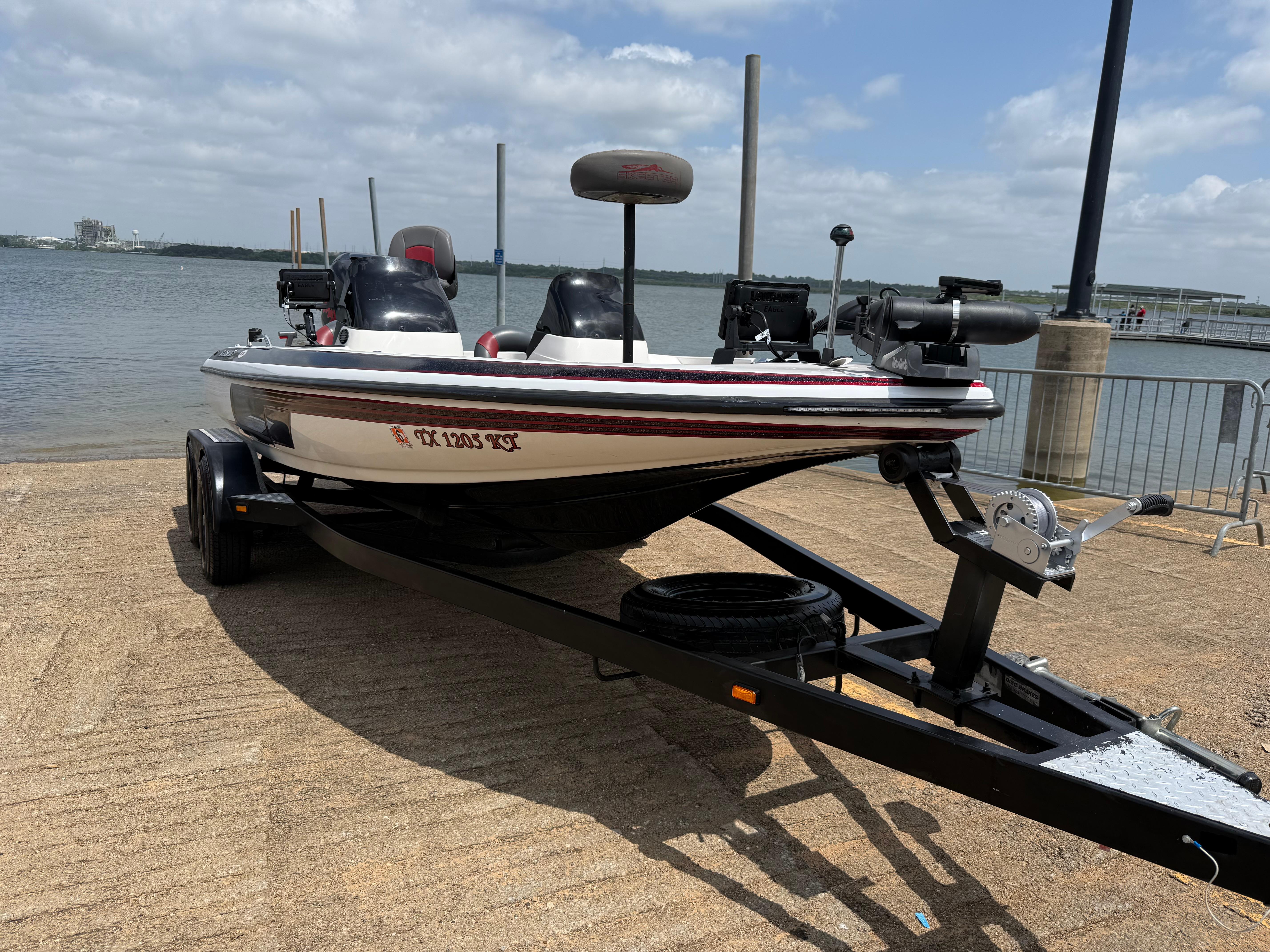 2003 Skeeter SX190 boat on trailer by lakeside.
