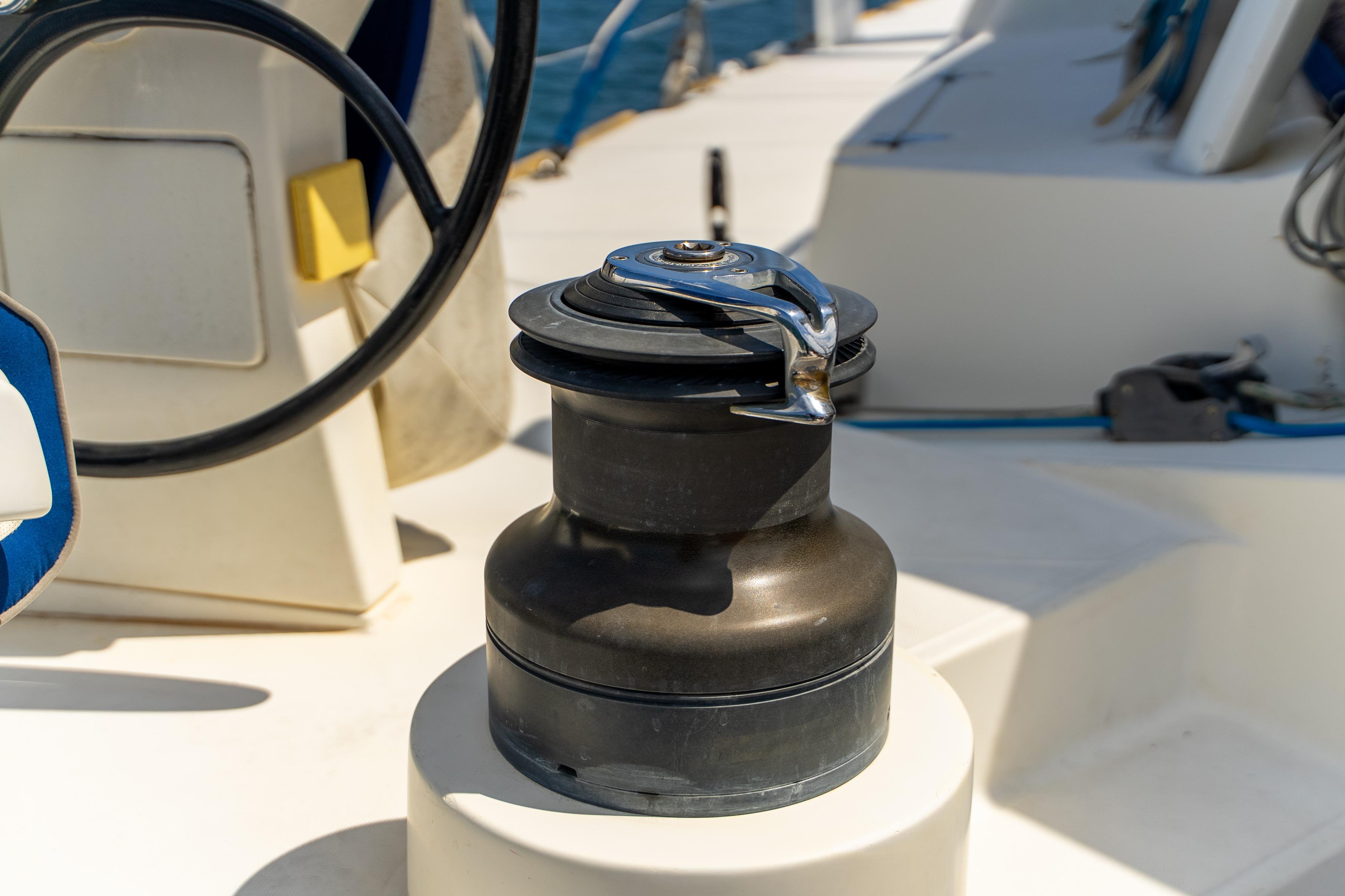 Winch on 2009 Catana 65 yacht deck, featuring steering wheel and nautical equipment.