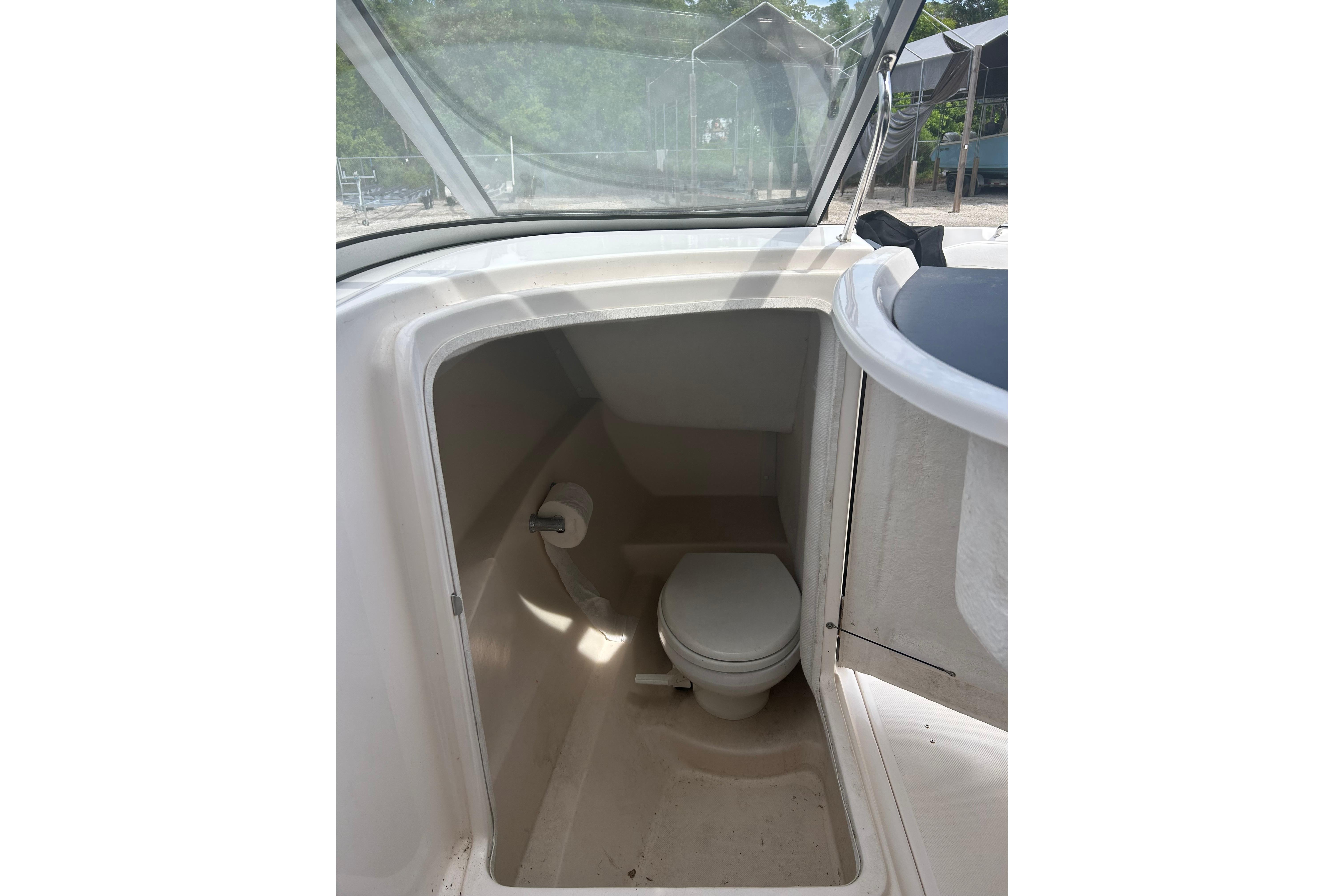 2008 Regal 2700 Bowrider boat interior with compact marine toilet.