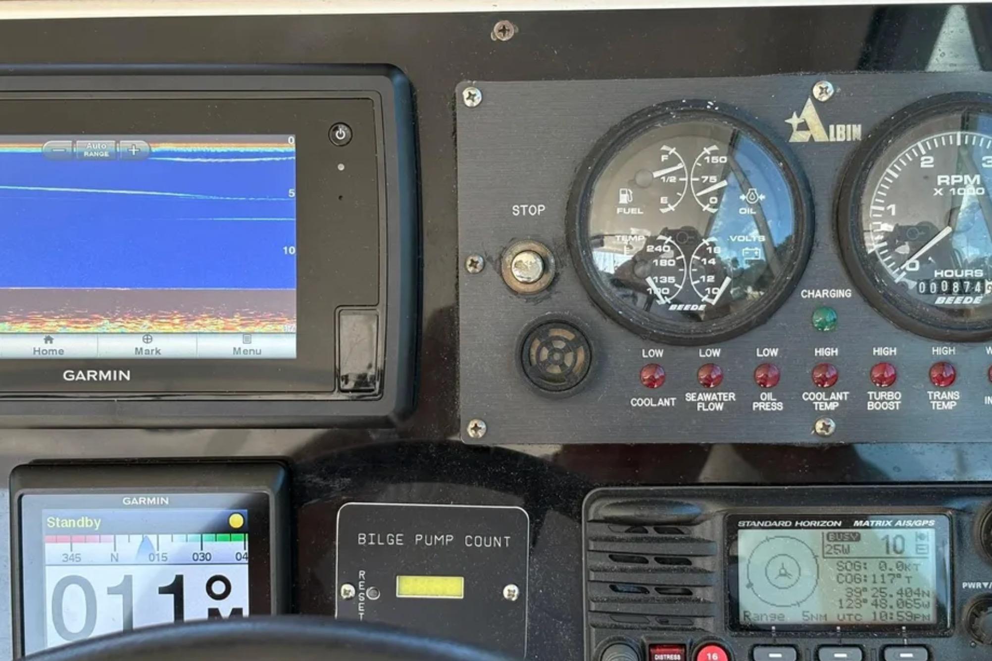 Dashboard of a 2005 Albin 28 Tournament Express with Garmin navigation and gauges.