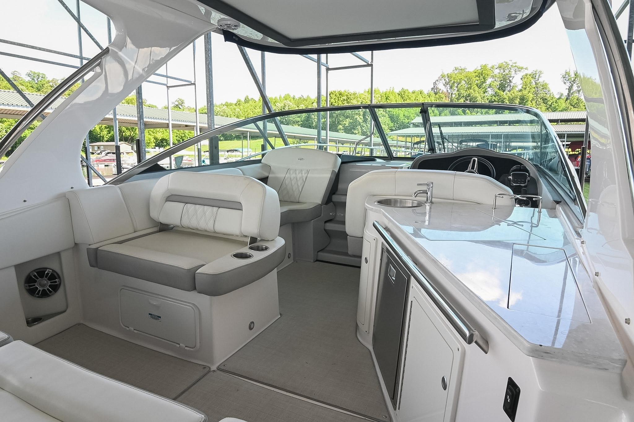 Interior of a 2021 Regal 33 Express boat with seating and kitchenette.