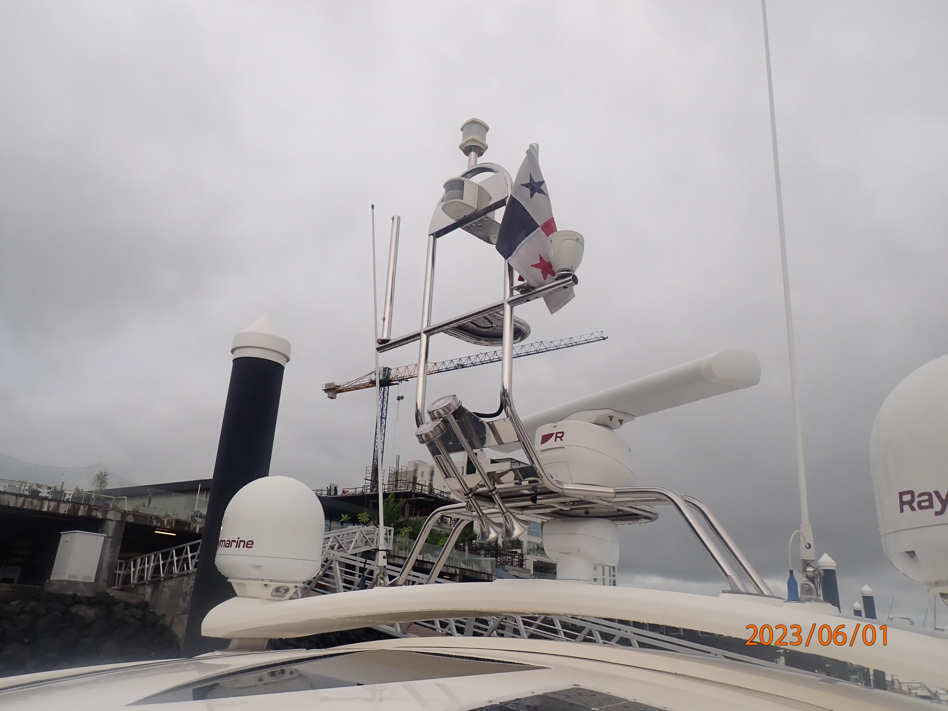 2007 Fairline Targa 52 GT yacht with radar and flag, docked under cloudy skies.