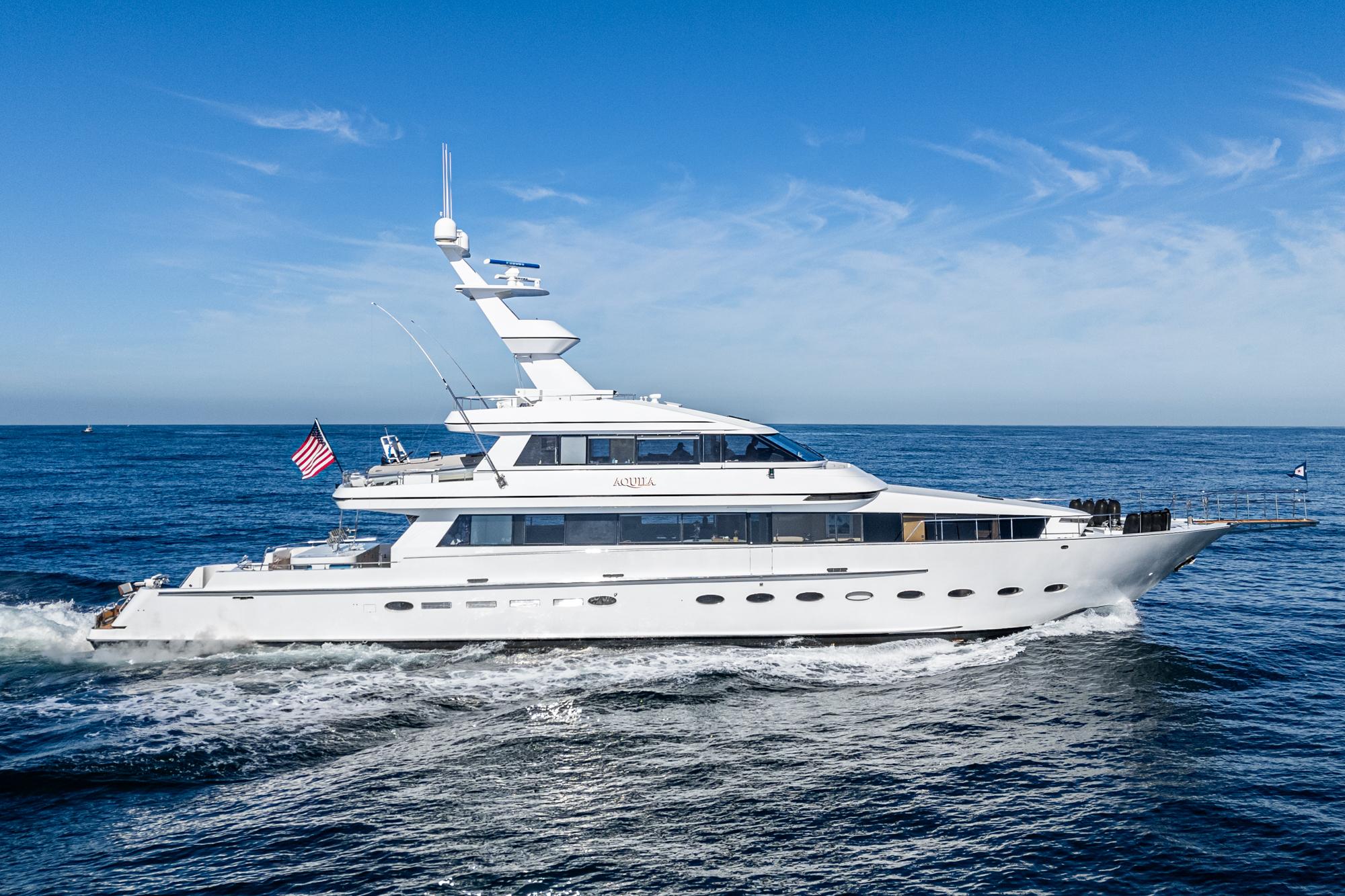Luxurious 1992 Barattucci Yacht Fisher cruising on open sea under clear blue sky.