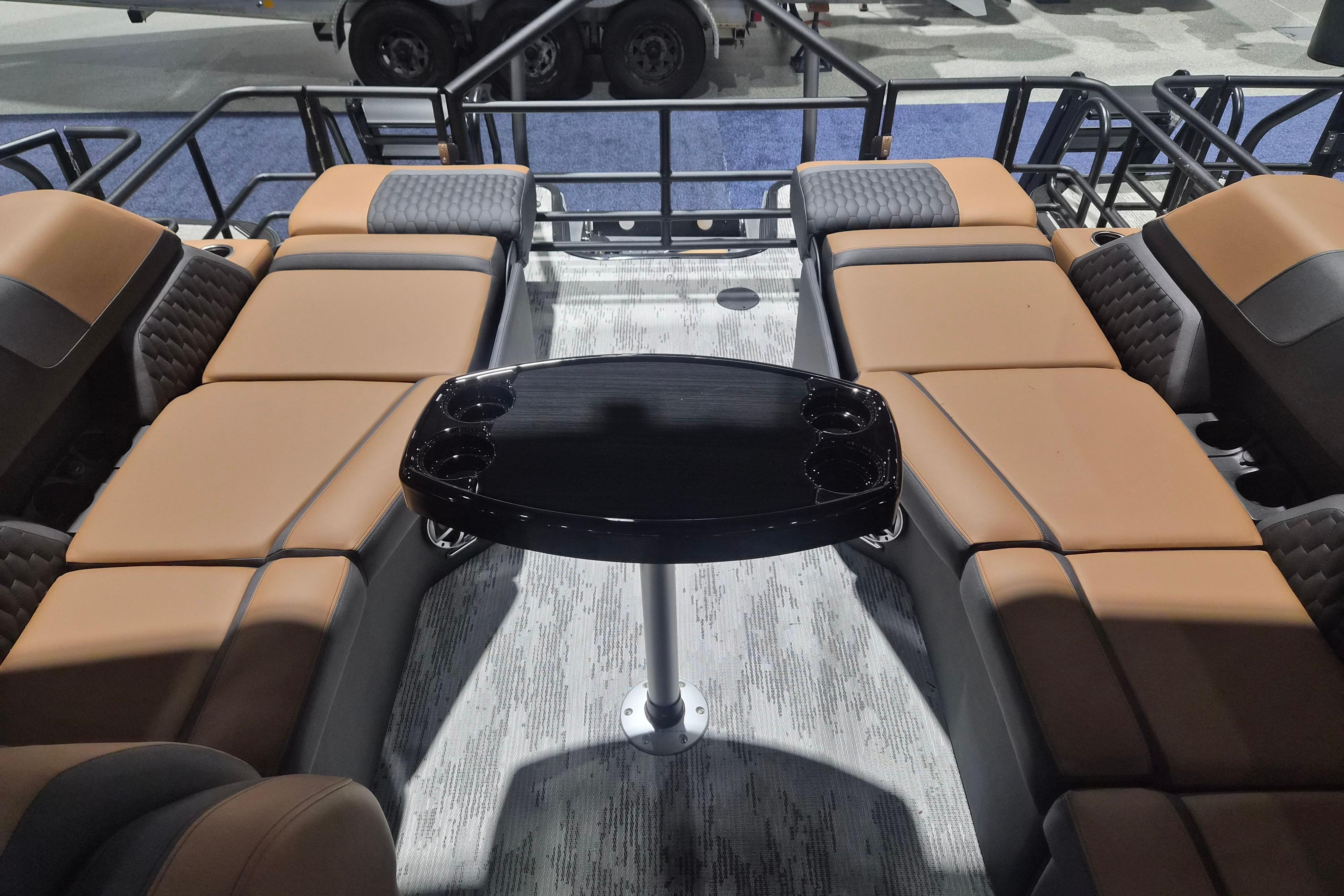 Luxurious interior of 2026 Sylvan L3 SLZ pontoon boat with plush seating and sleek table.