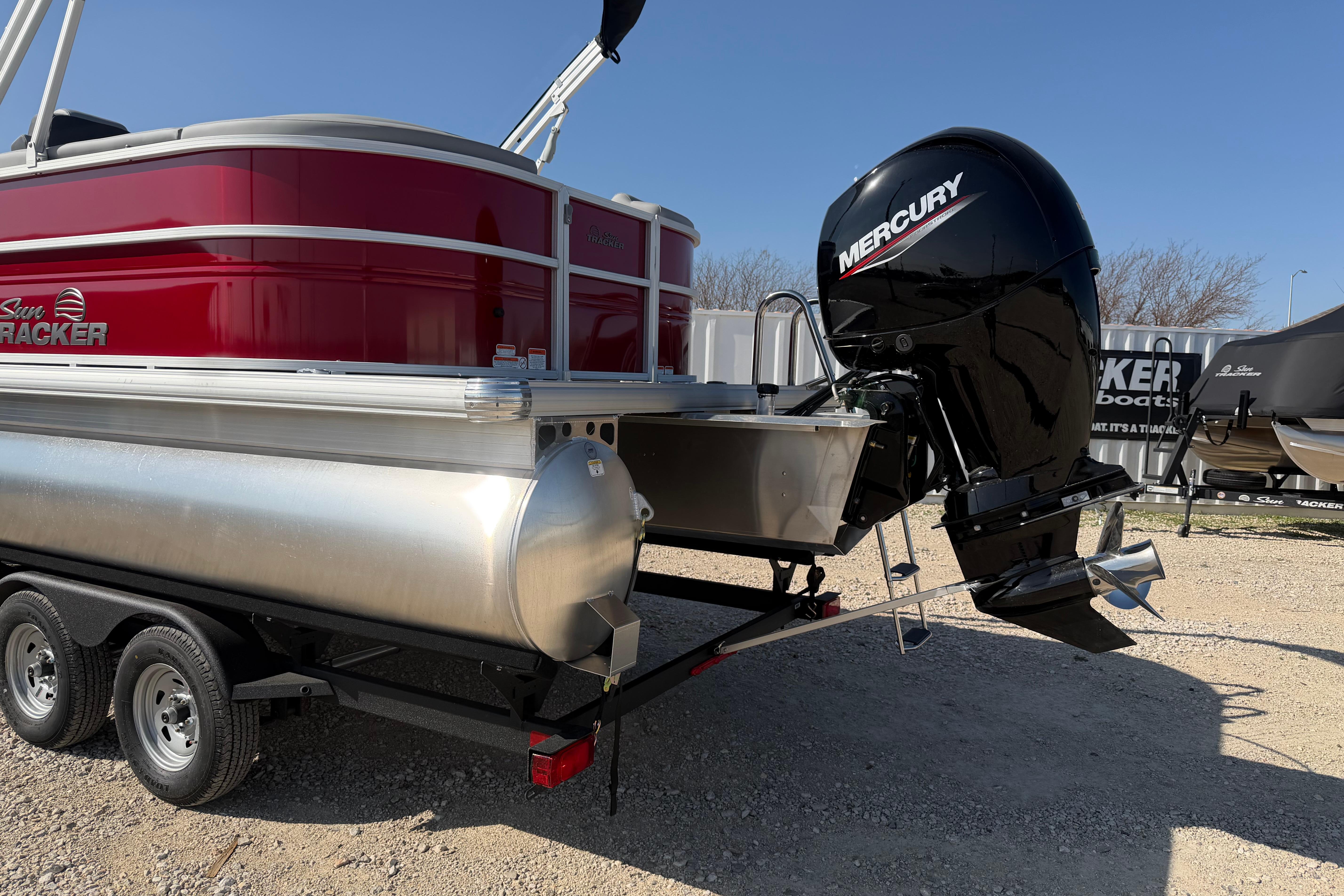 2026 Sun Tracker Party Barge 22 DLX with Mercury outboard motor on trailer.