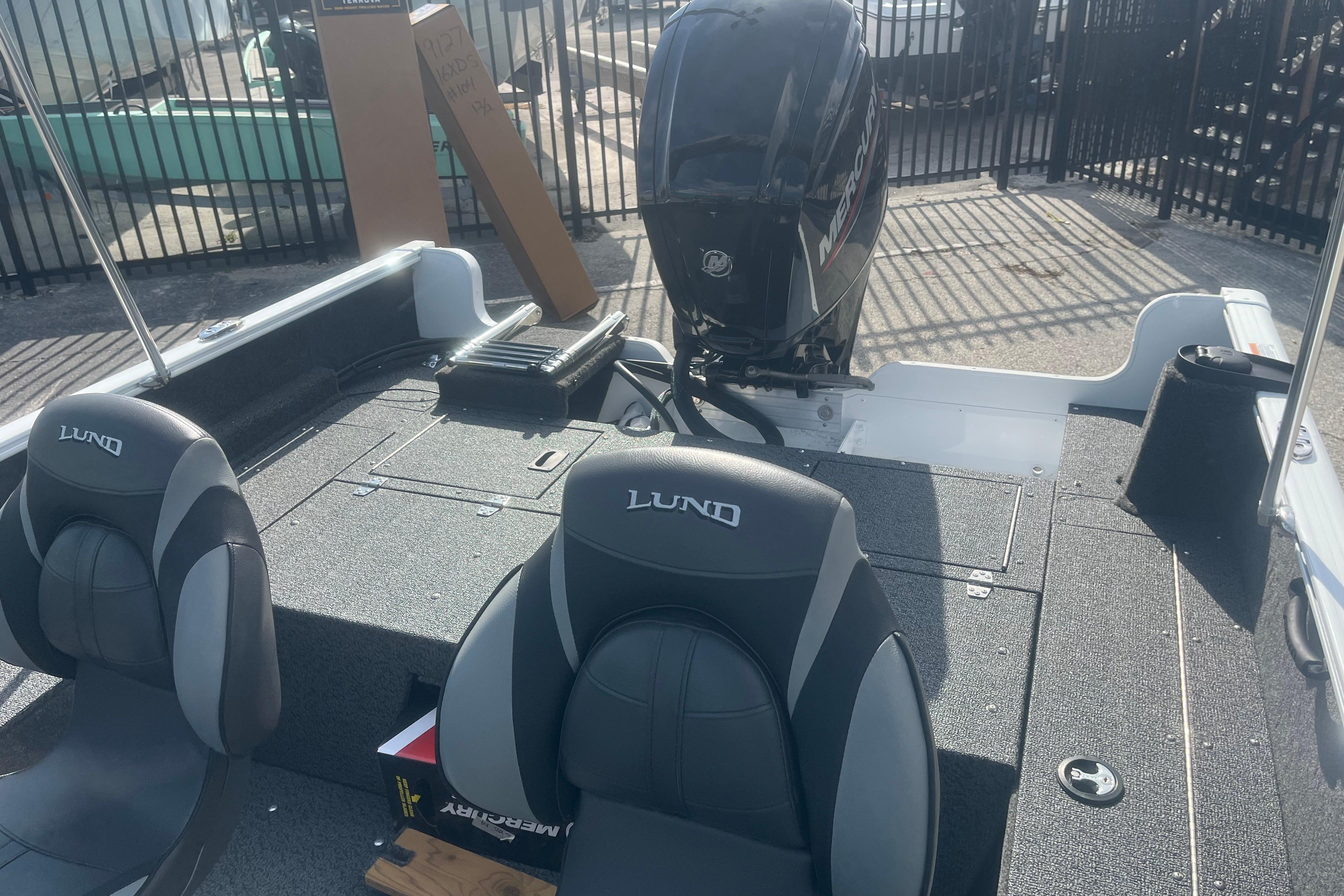 2026 Lund 1650 Rebel XL Sport boat interior with Mercury engine, featuring comfortable seating.