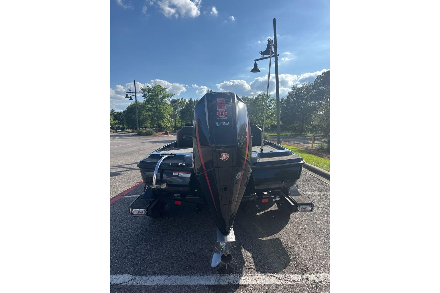 2026 Nitro Z21 XL boat with V8 engine parked outdoors under a clear sky.