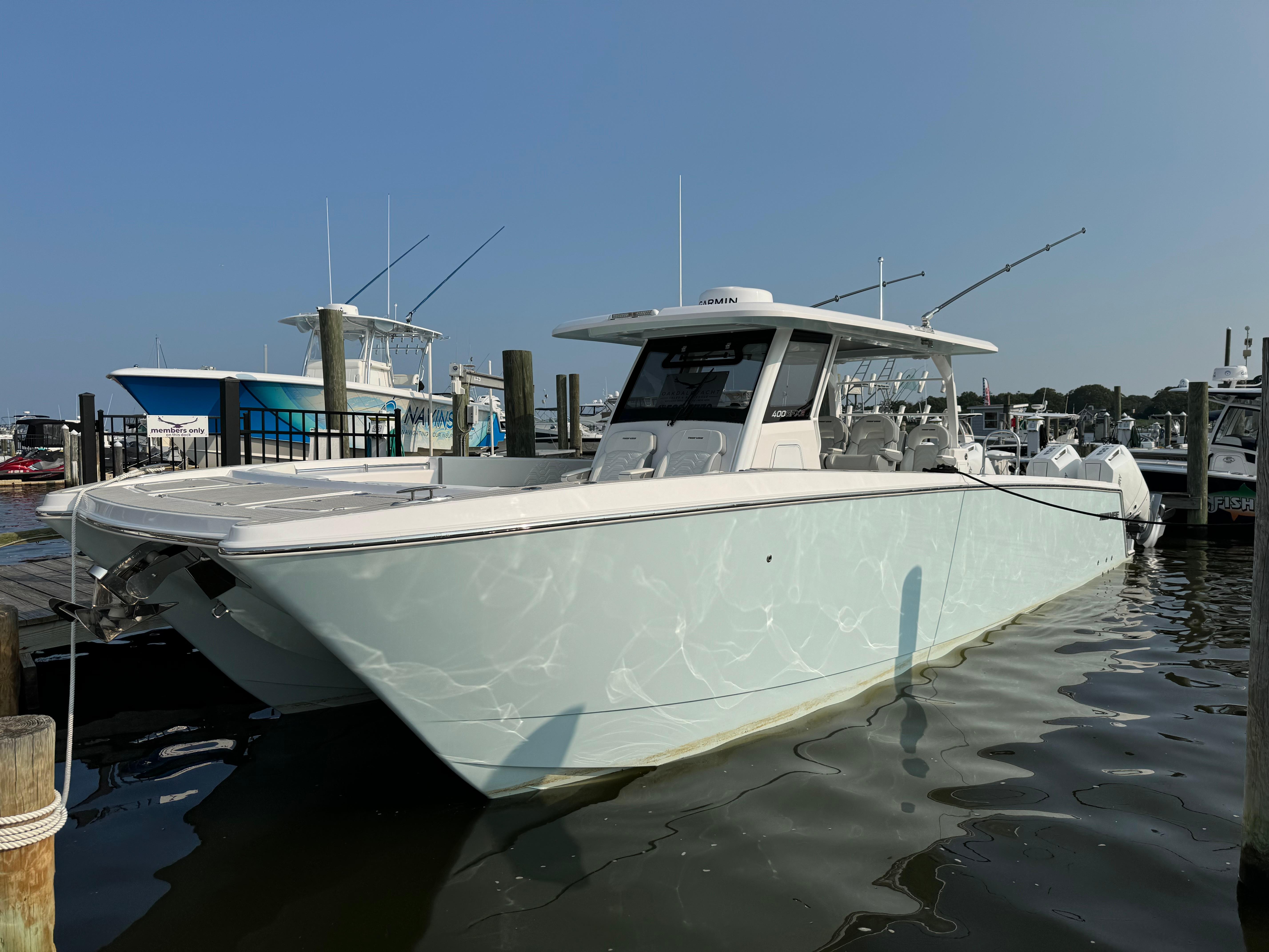 2025 Twin Vee 400 GFX boat docked at a marina.