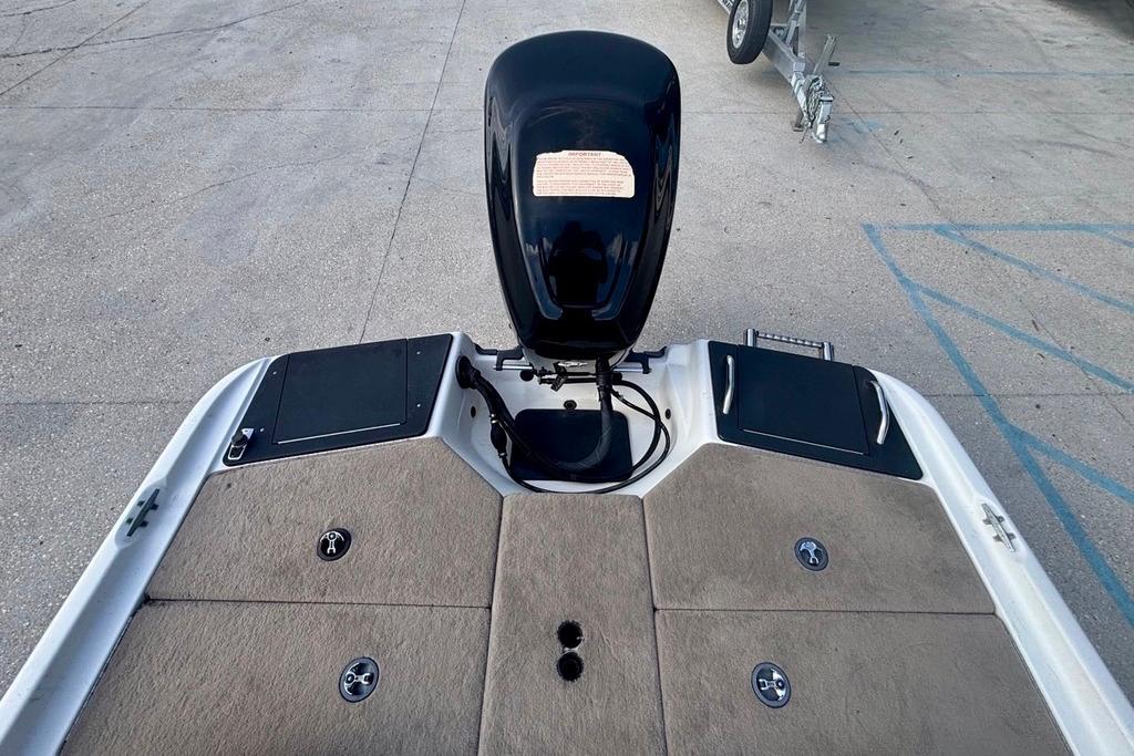 2008 Ranger 180 Reata boat deck with motor, carpeted surface, and storage compartments.