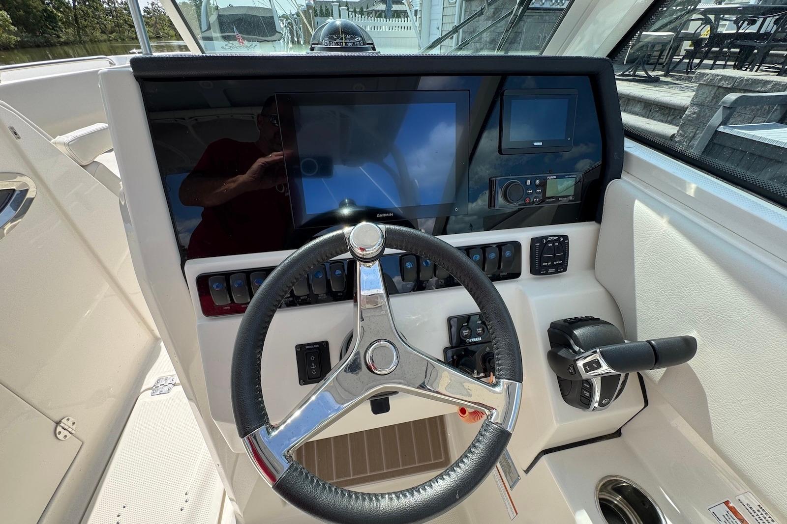 2022 Sailfish 276 DC boat dashboard with steering wheel and control panel.