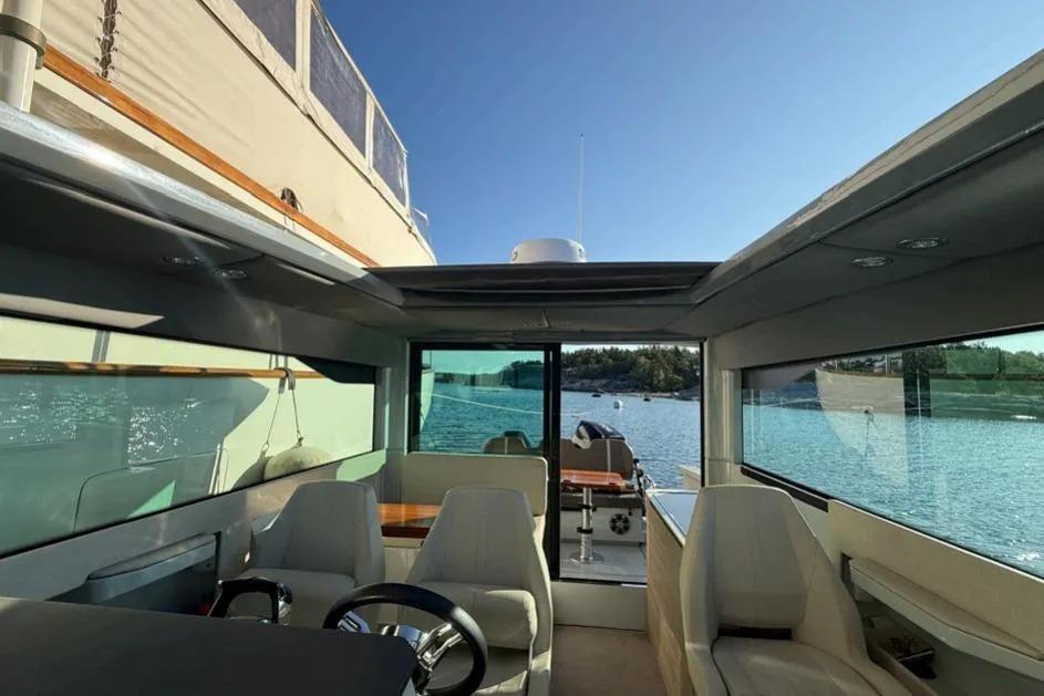 Interior view of 2022 Saxdor 320 GTC yacht with scenic water backdrop.