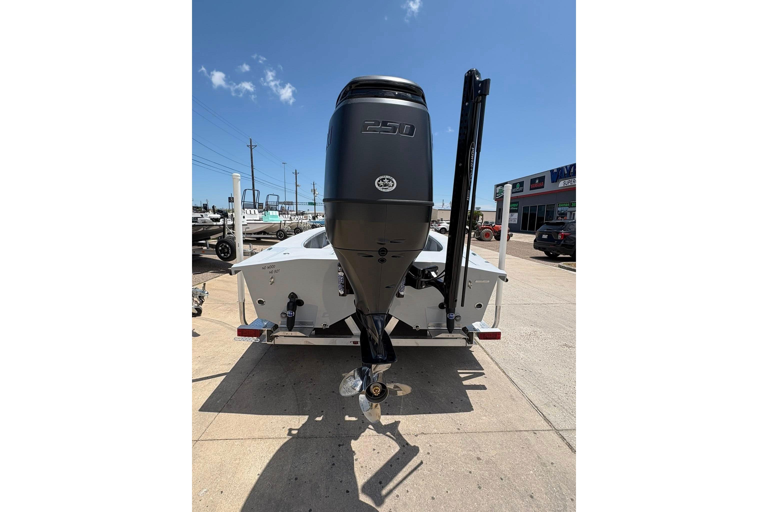 2026 Freedom Boats 23' Warrior with powerful outboard motor, parked outdoors.