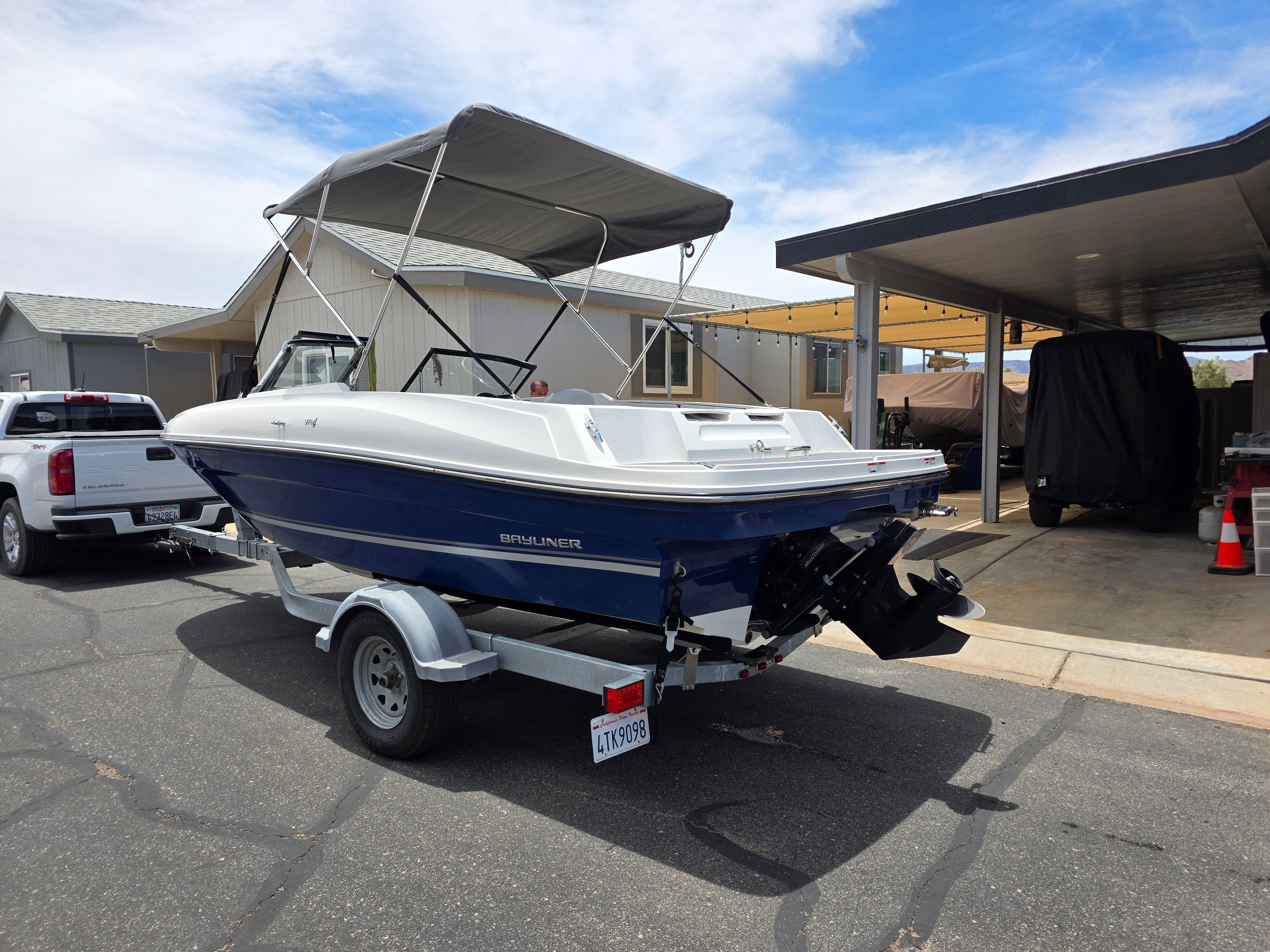 A 2021 Bayliner VR4 Bowrider I/O on a trailer in a driveway.