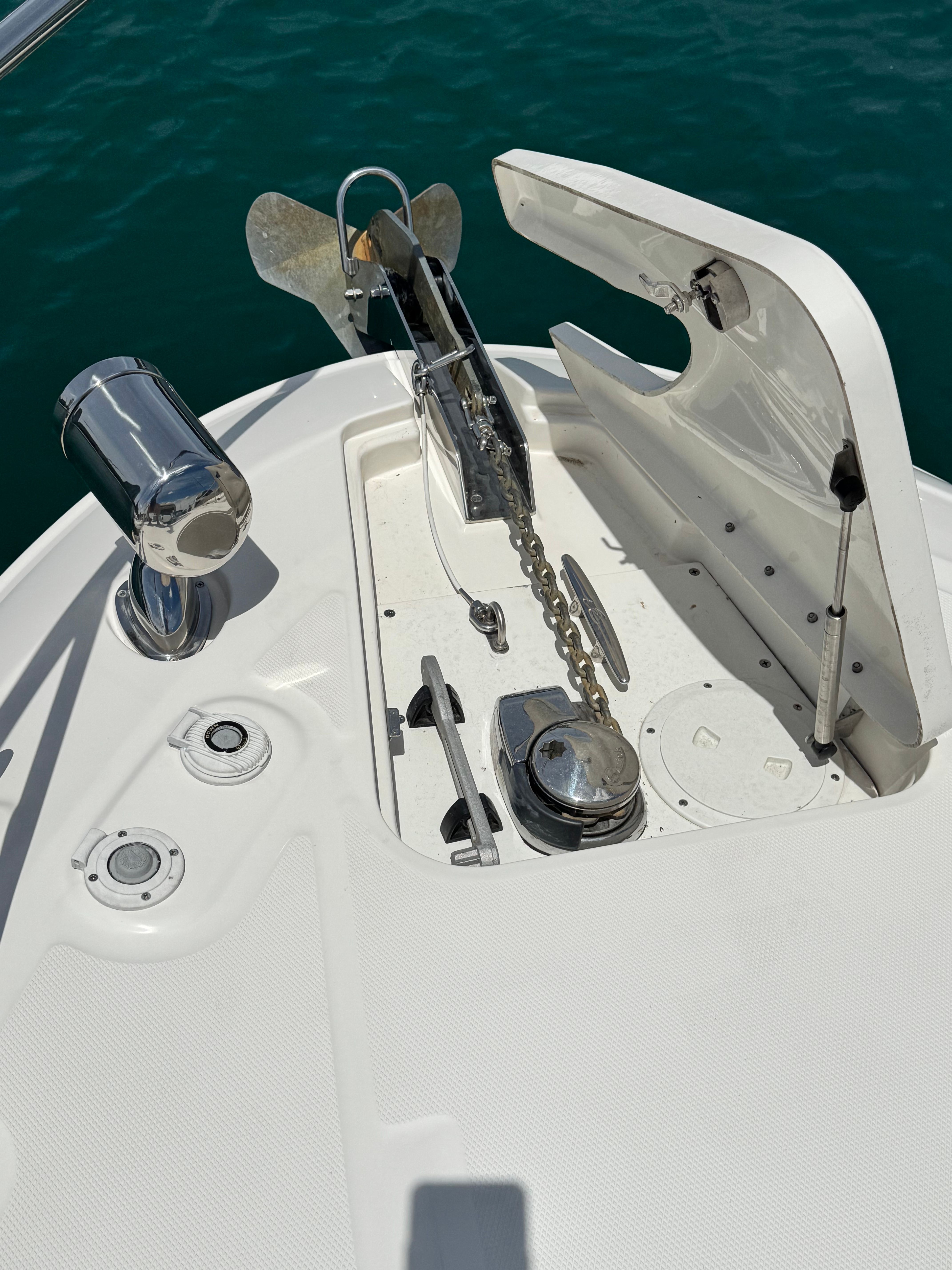 The bow of a Sea Ray Sundancer 310 with anchor windlass and chain.