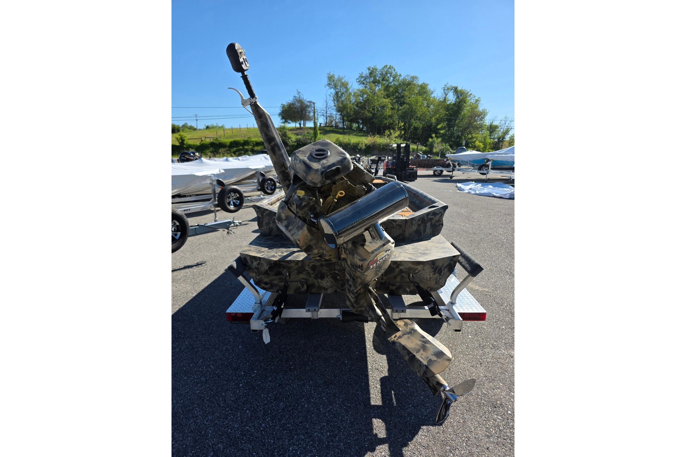 2026 Excel 1854 F4 boat with camouflage design on a trailer in a parking lot.
