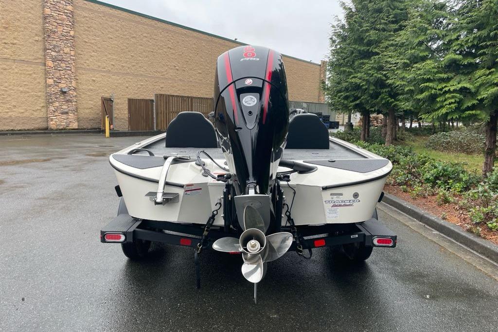 2025 Tracker Savage 215 boat on trailer, rear view, parked outdoors.