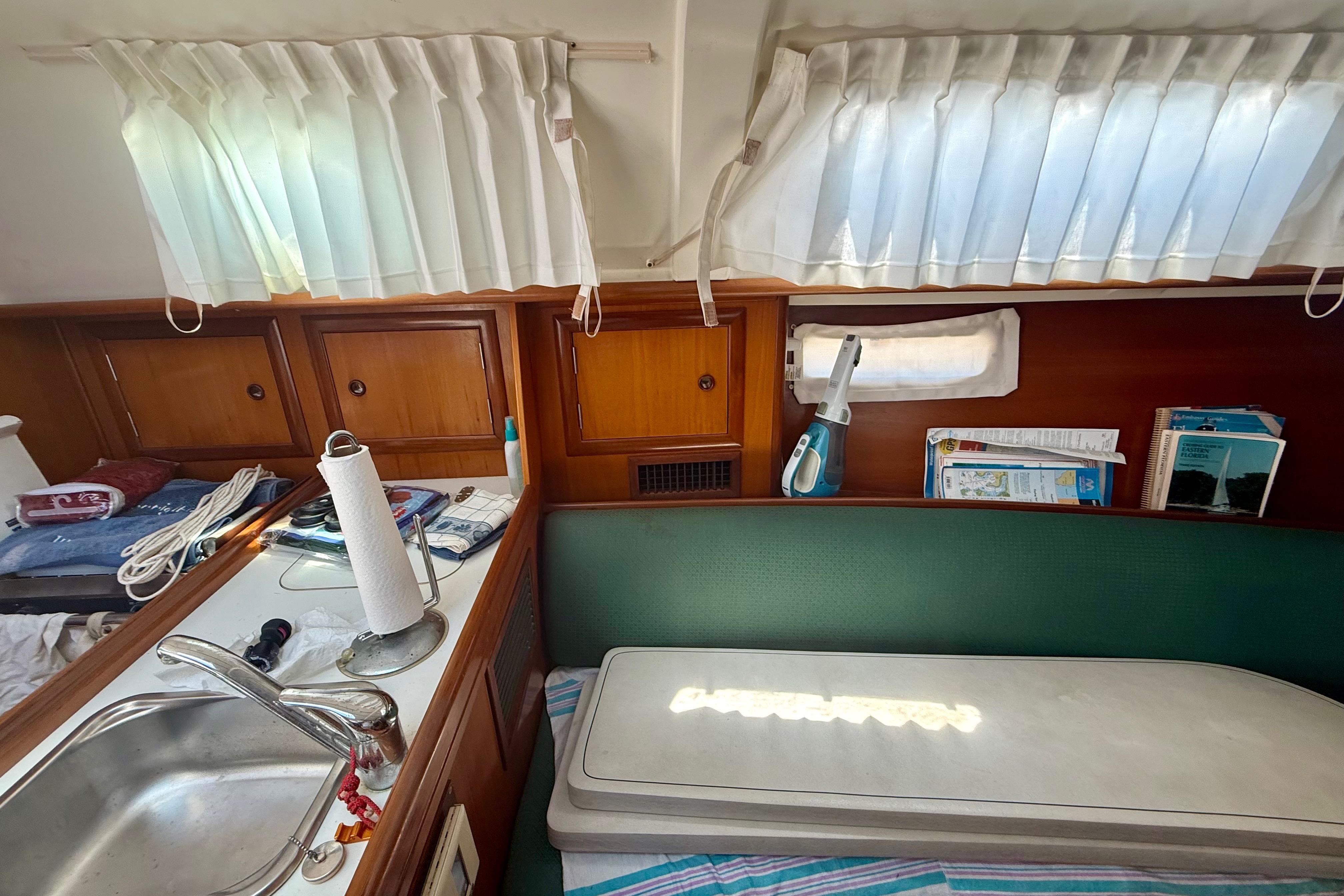 Interior of 2002 Beneteau Oceanis Clipper 311 sailboat with kitchen and seating area.