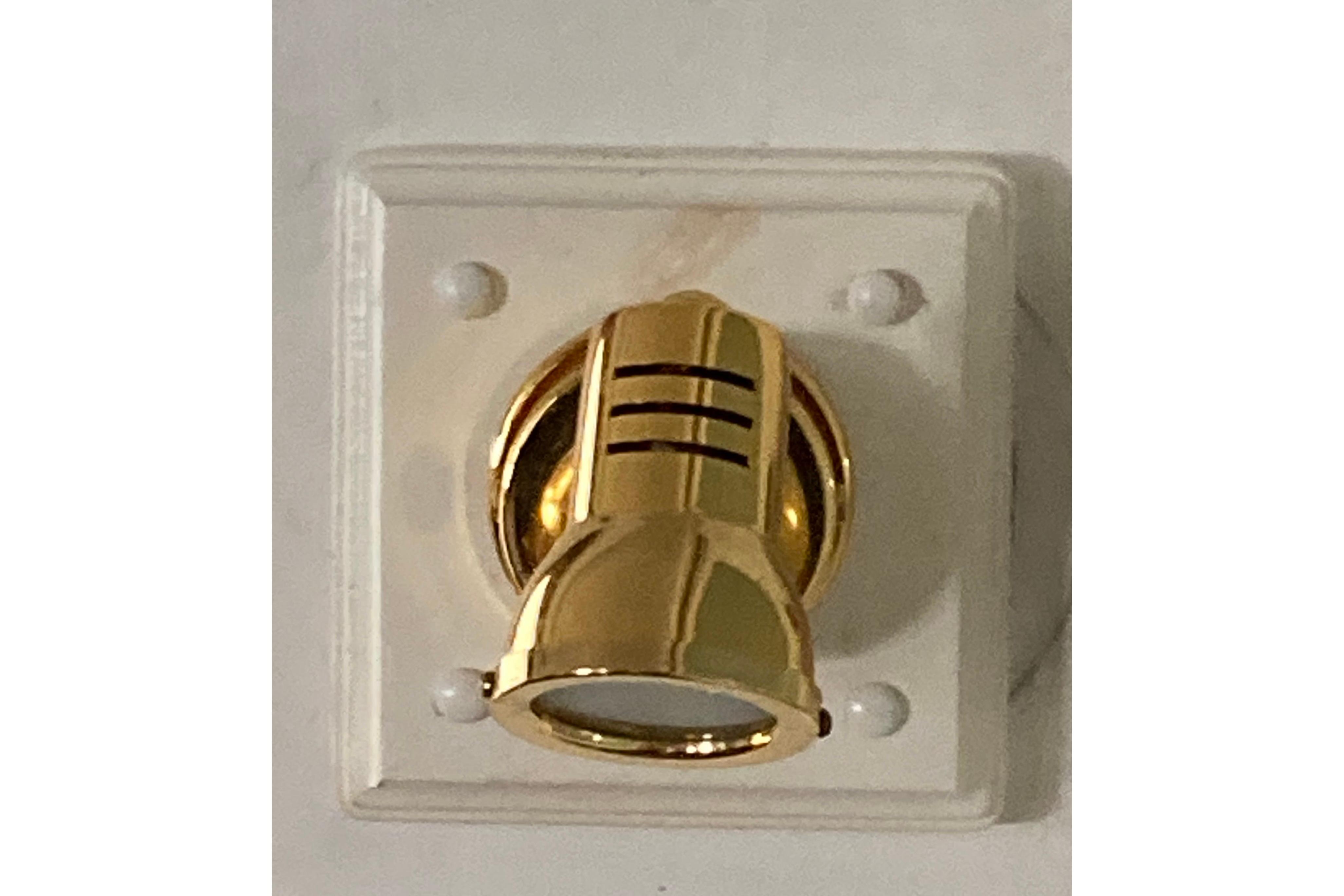Gold spotlight fixture on white wall, Grenfell 42 Custom, 1942 vintage design.