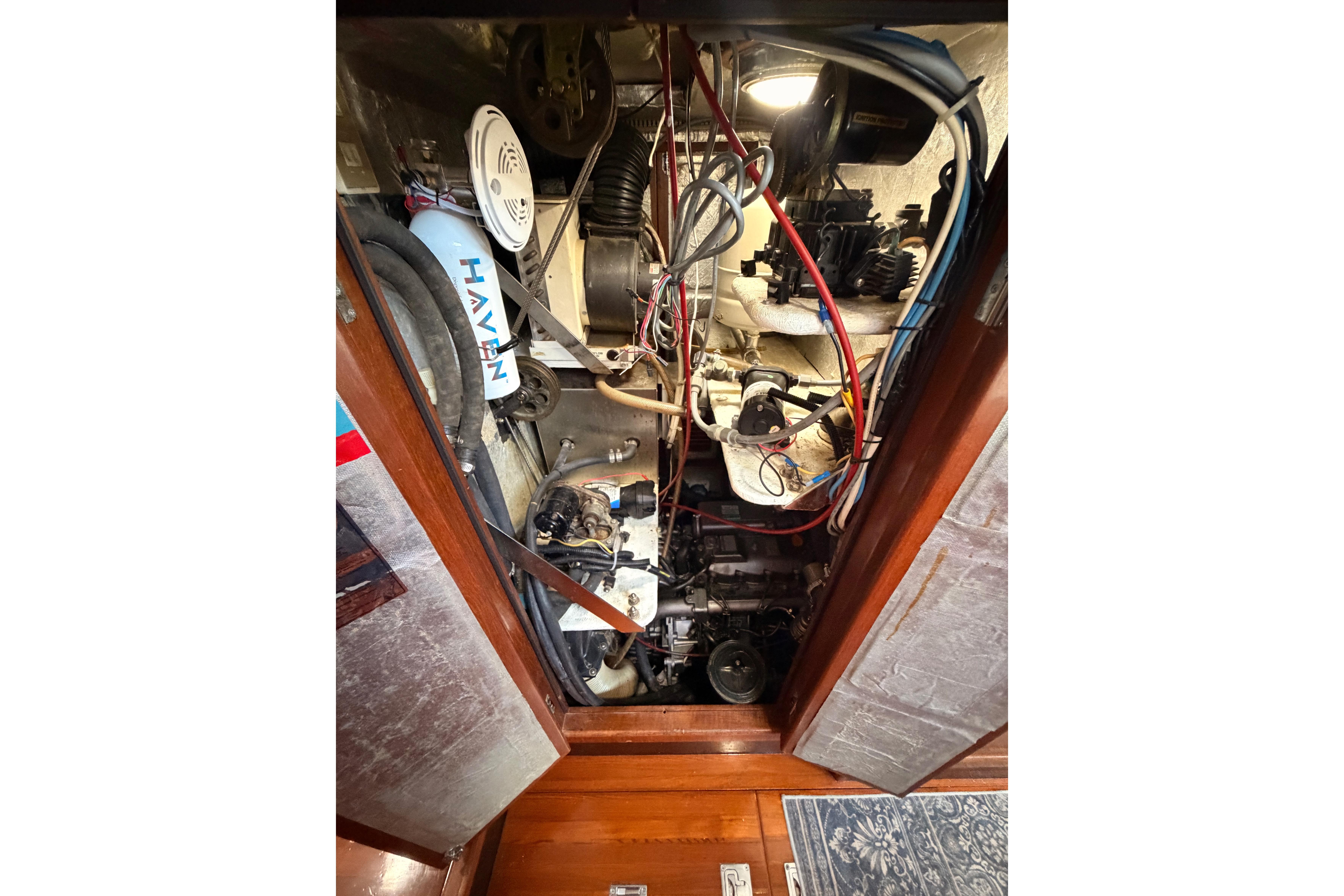Engine compartment of a 1991 Hylas 51 yacht, showcasing wiring and mechanical components.